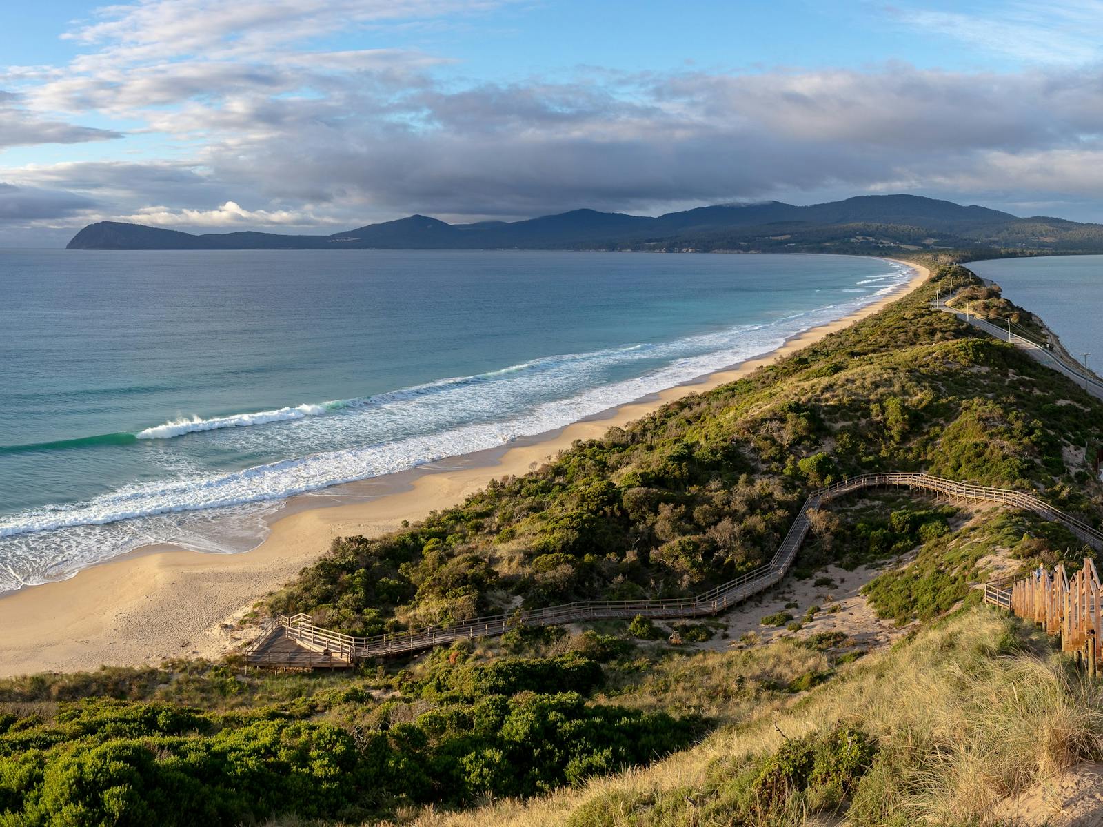 Panoramic view from the Neck lookout at Bruny Island. Water surrounding a thin strip of land.