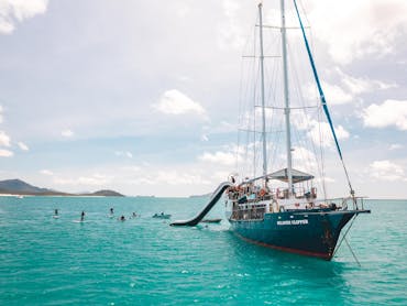 A photo of Atlantic Clipper with two waterslides and people paddleboarding