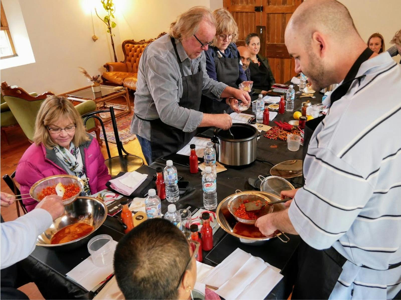 a group of people straining the chilli sauce