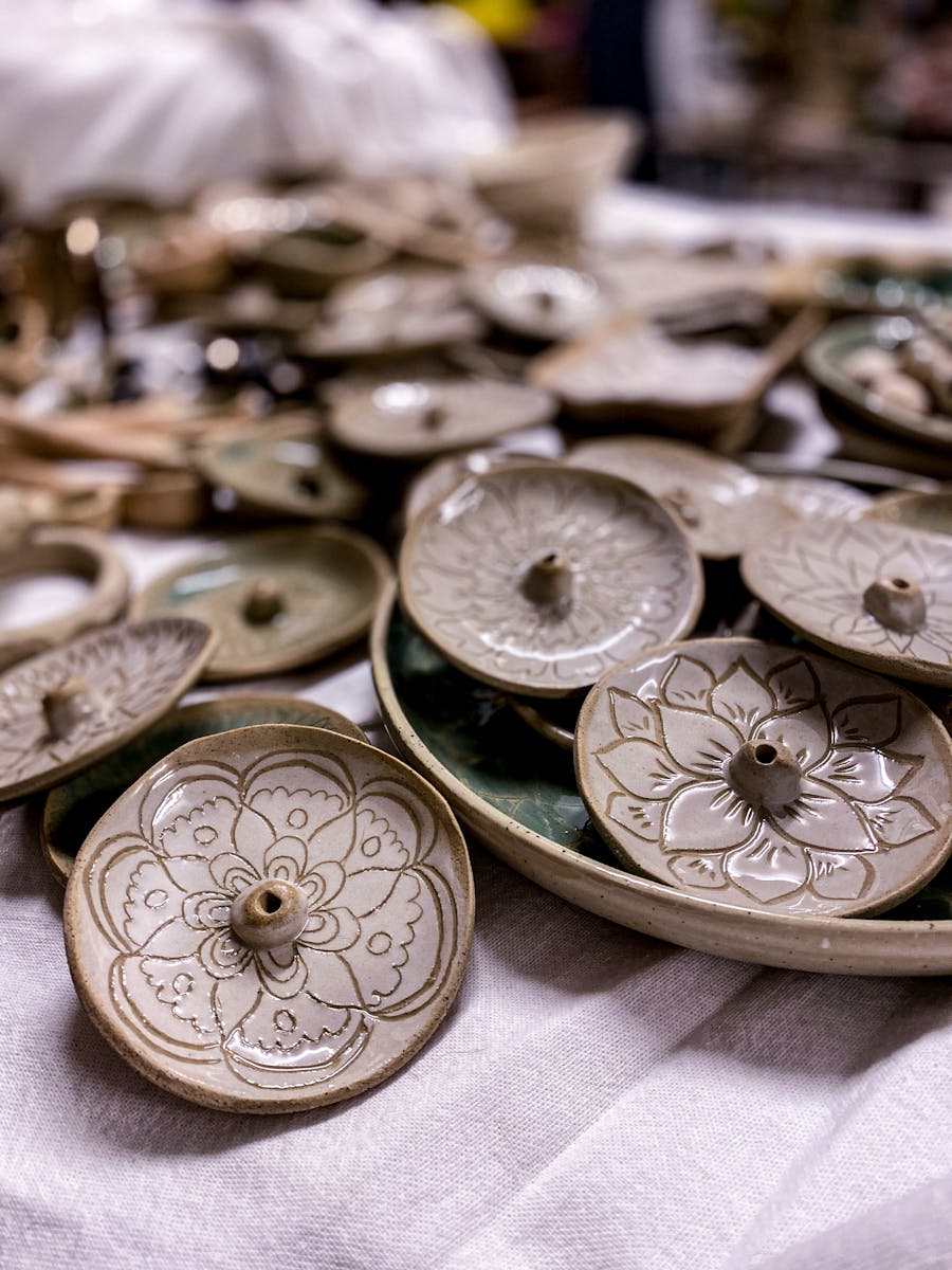 photo shows a close of handmade incense burners with handcarved designs