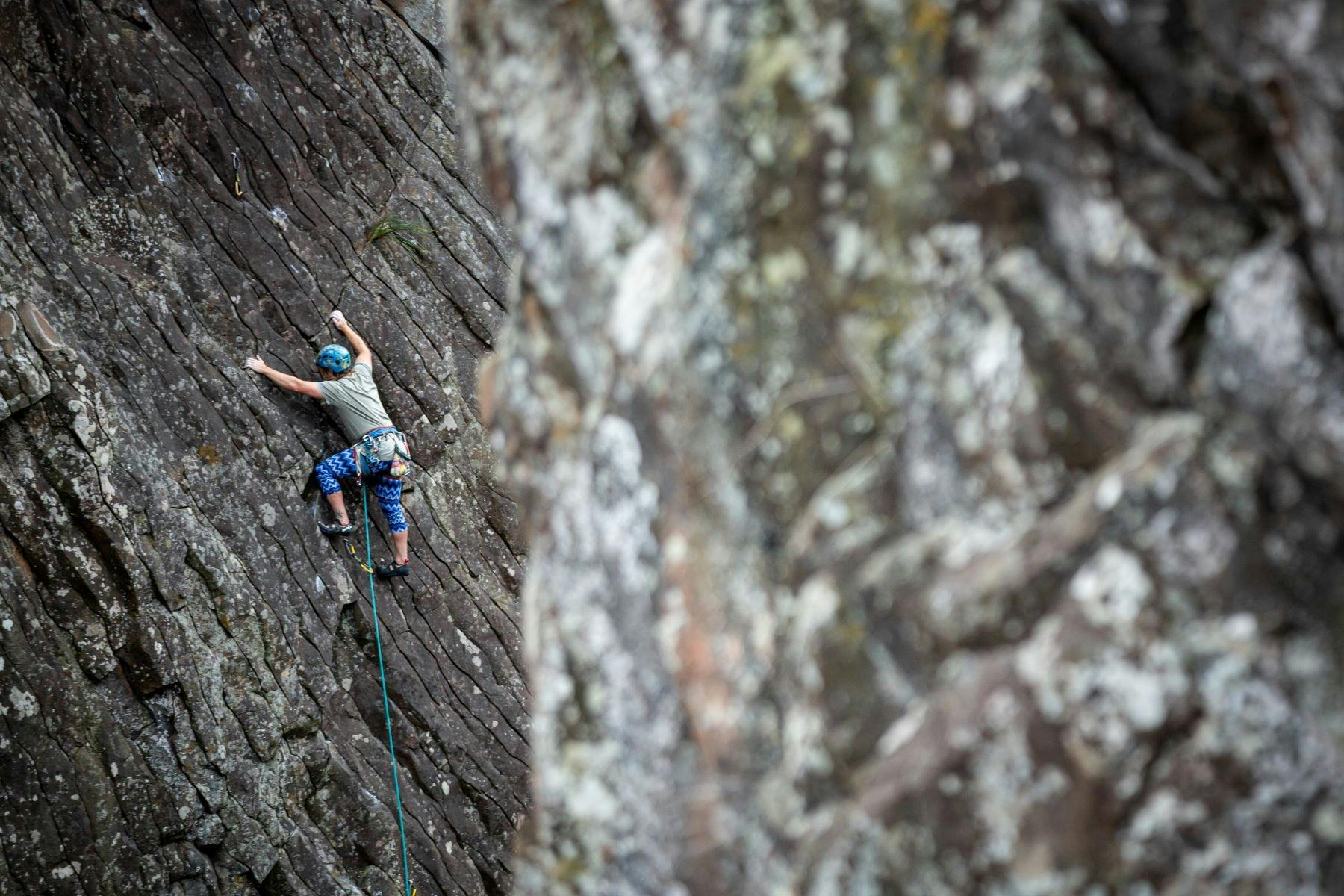 A climber on a sheer rock face.