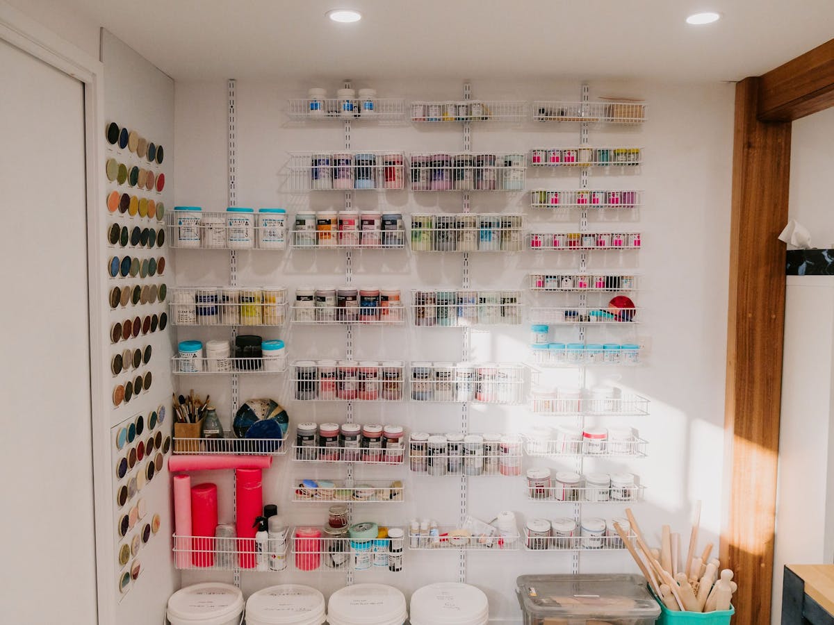 hanging metal shelves with many tubs of glazes available hanging metal shelves with many tubs of glazes available