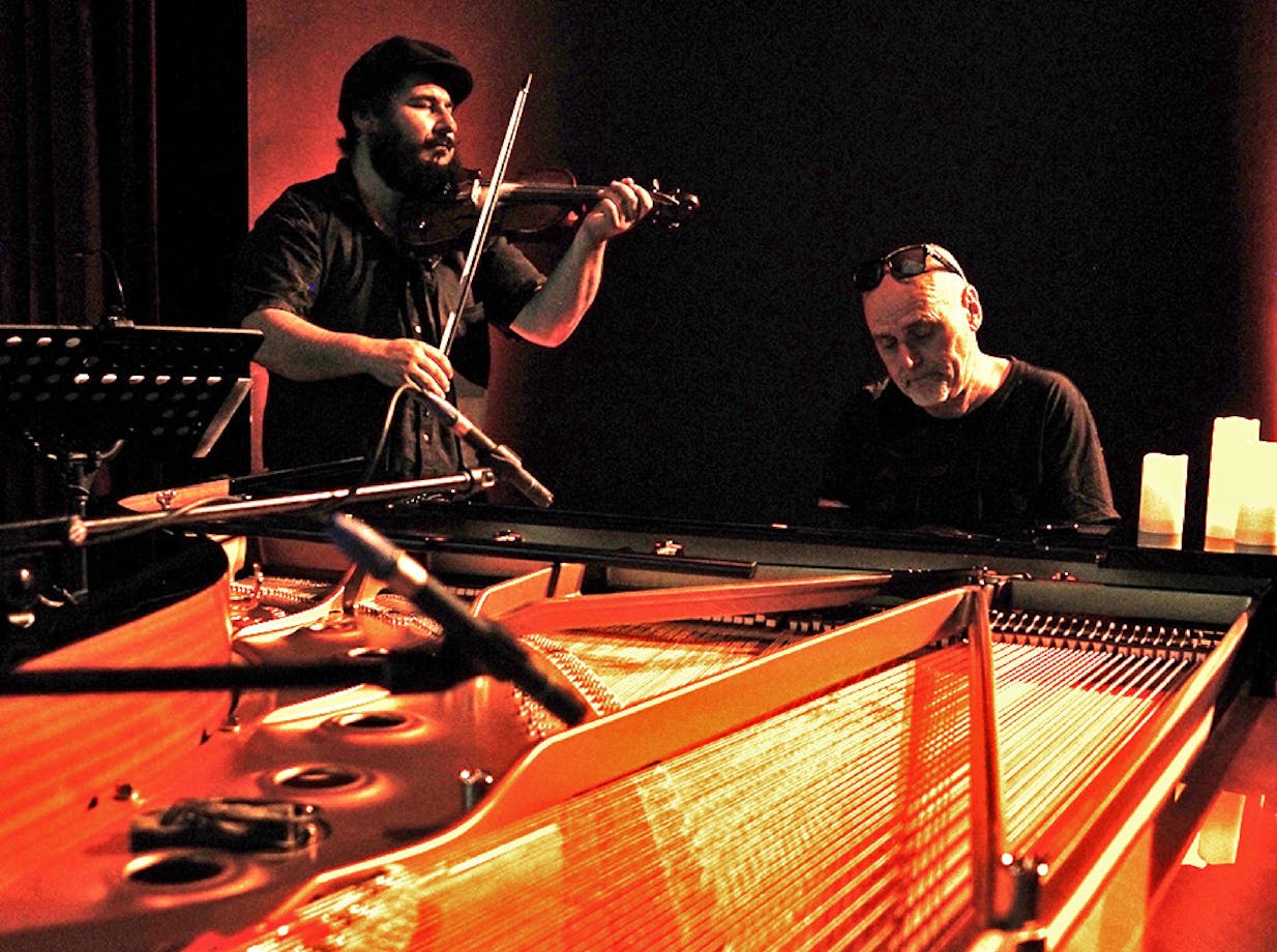 Alex Burkoy playing violin and Simon Reich playing grand piano