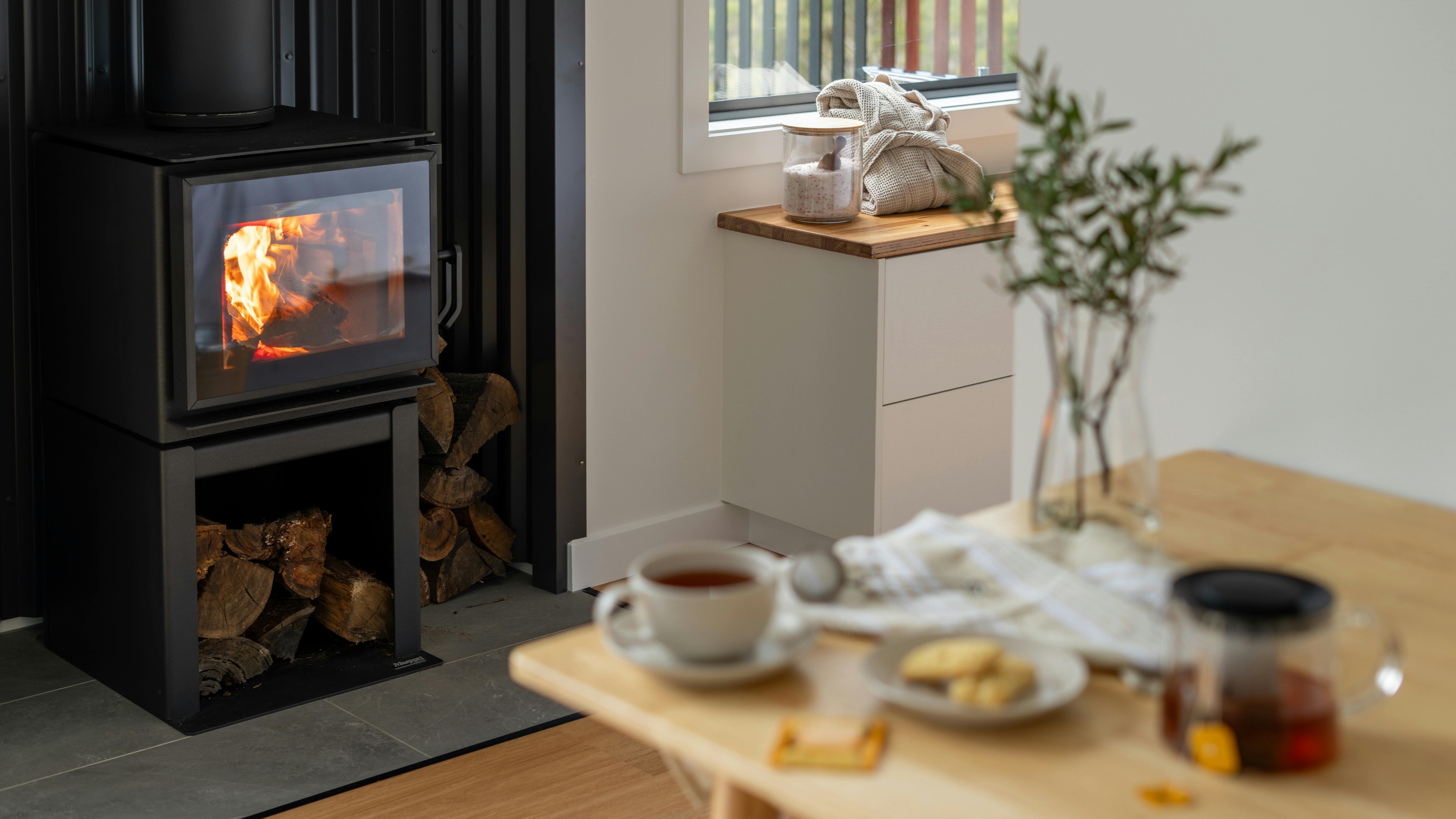 Morning tea of biscuits and tea next to a warm wood burner fireplace