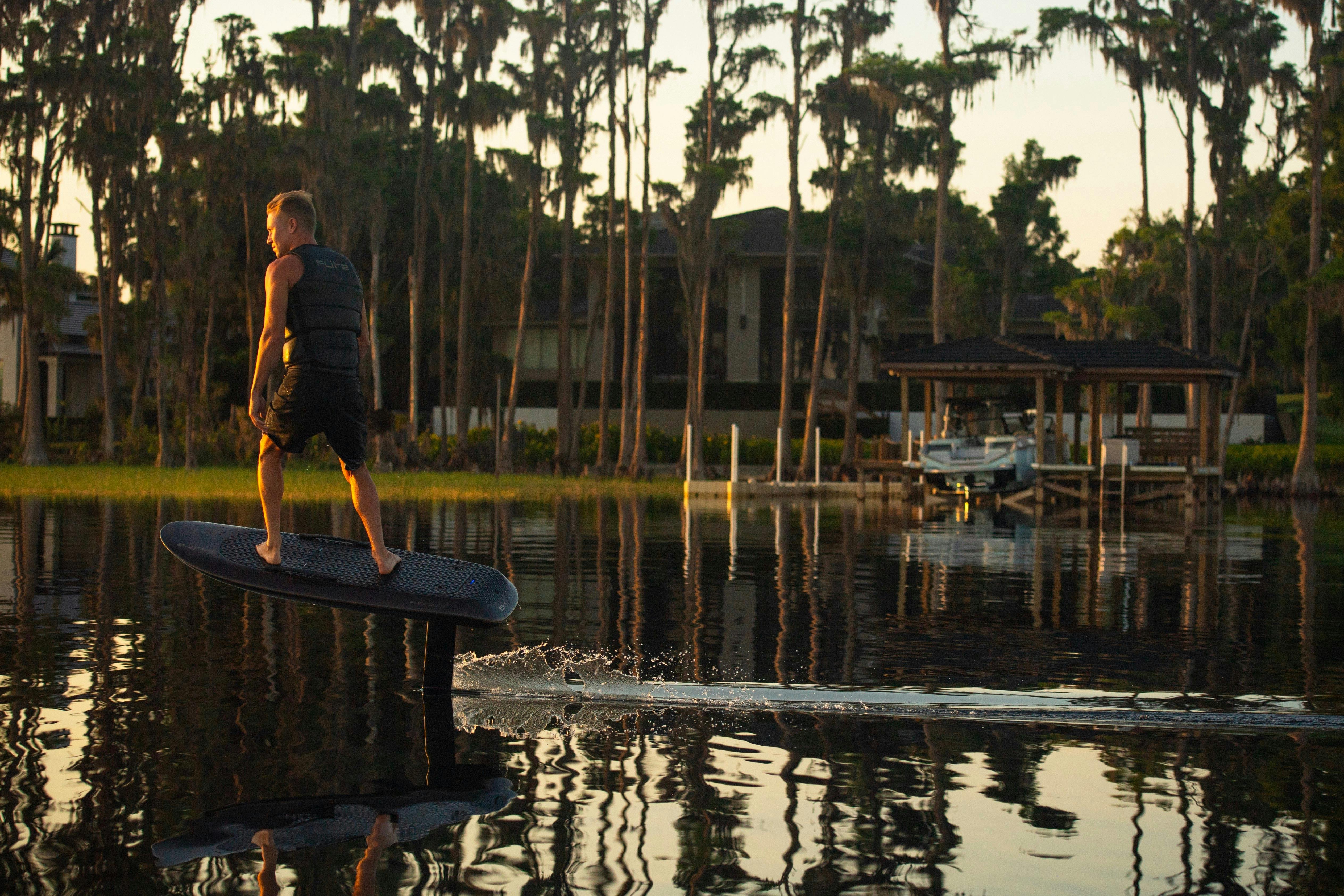 Man Foiling at Sunset Fliteboard and  Fliteschool Noosa