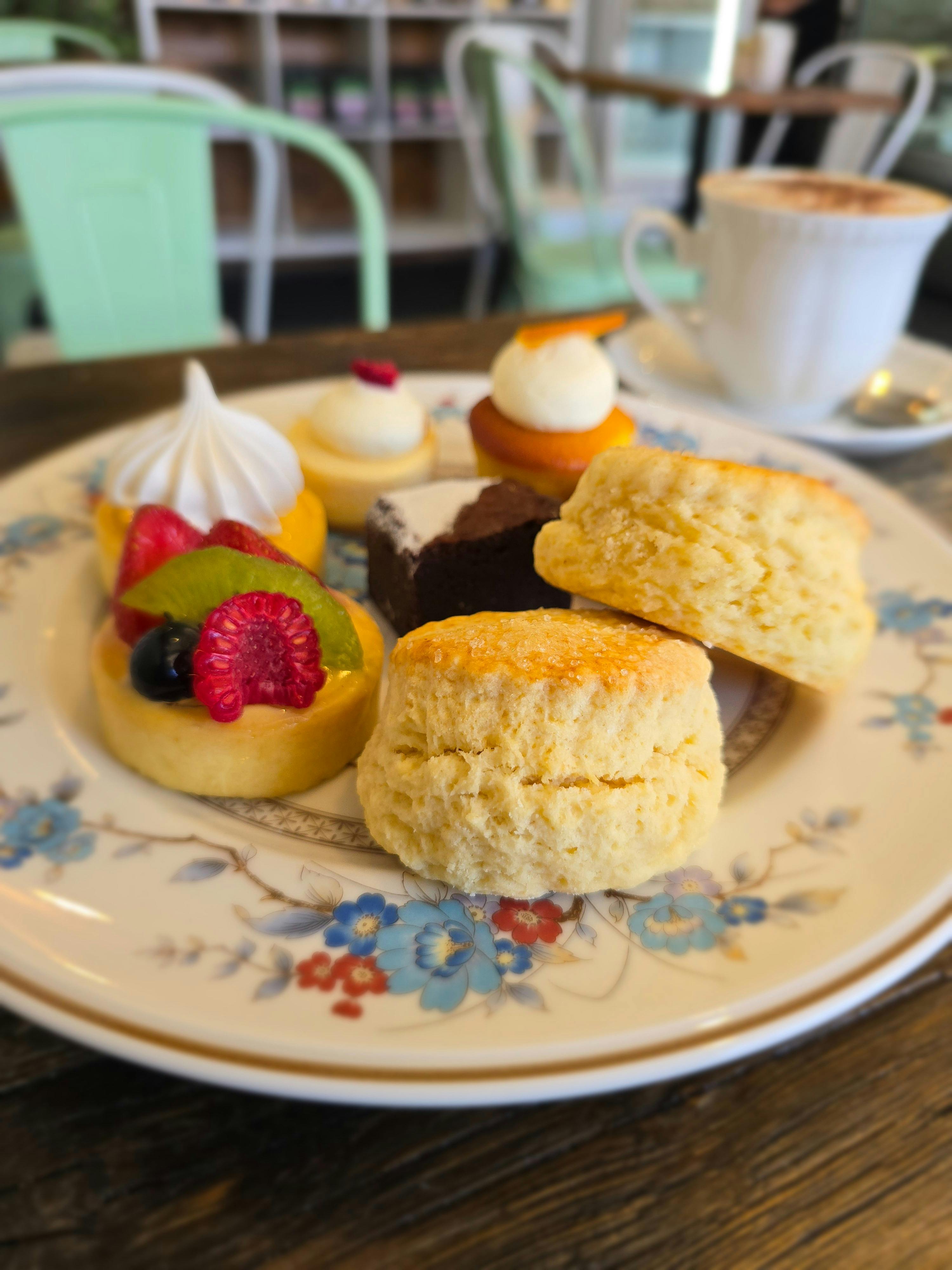 scones, tarts and a brownie on a white plate