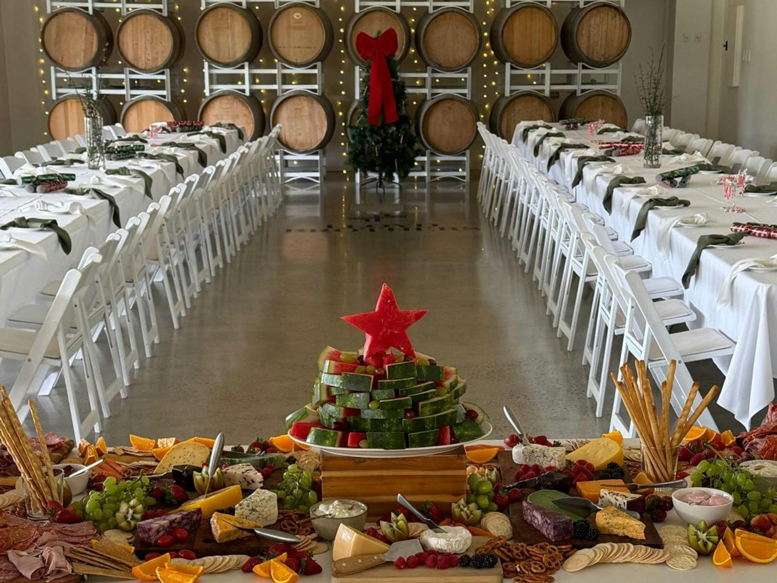 A beautifully arranged table featuring a Christmas tree and a grazing table