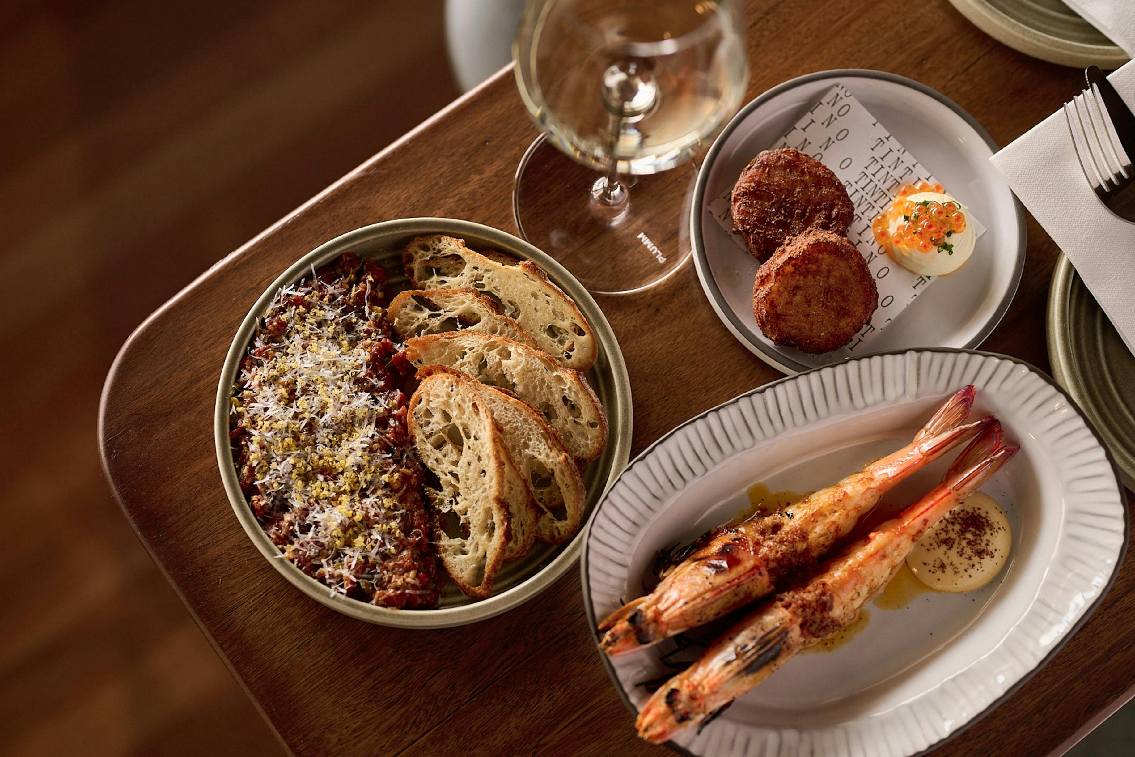 Beef Tartare + Gochujang + Sourdough Cracker, Yamba King Prawn + Aleppo Pepper, Flo's Potato Gems