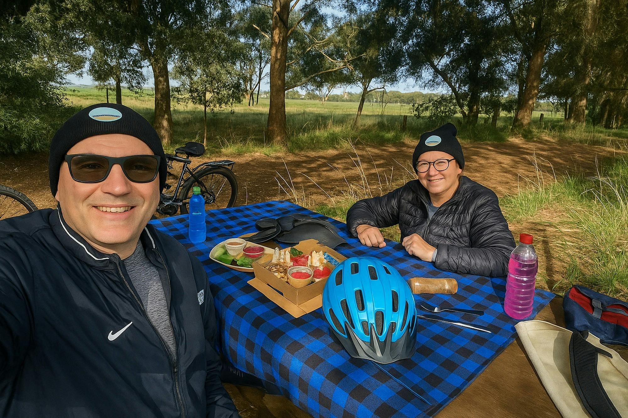 A couple enjoying a picnic during their self-guided e-bike ride along the coastal and hinterland tra