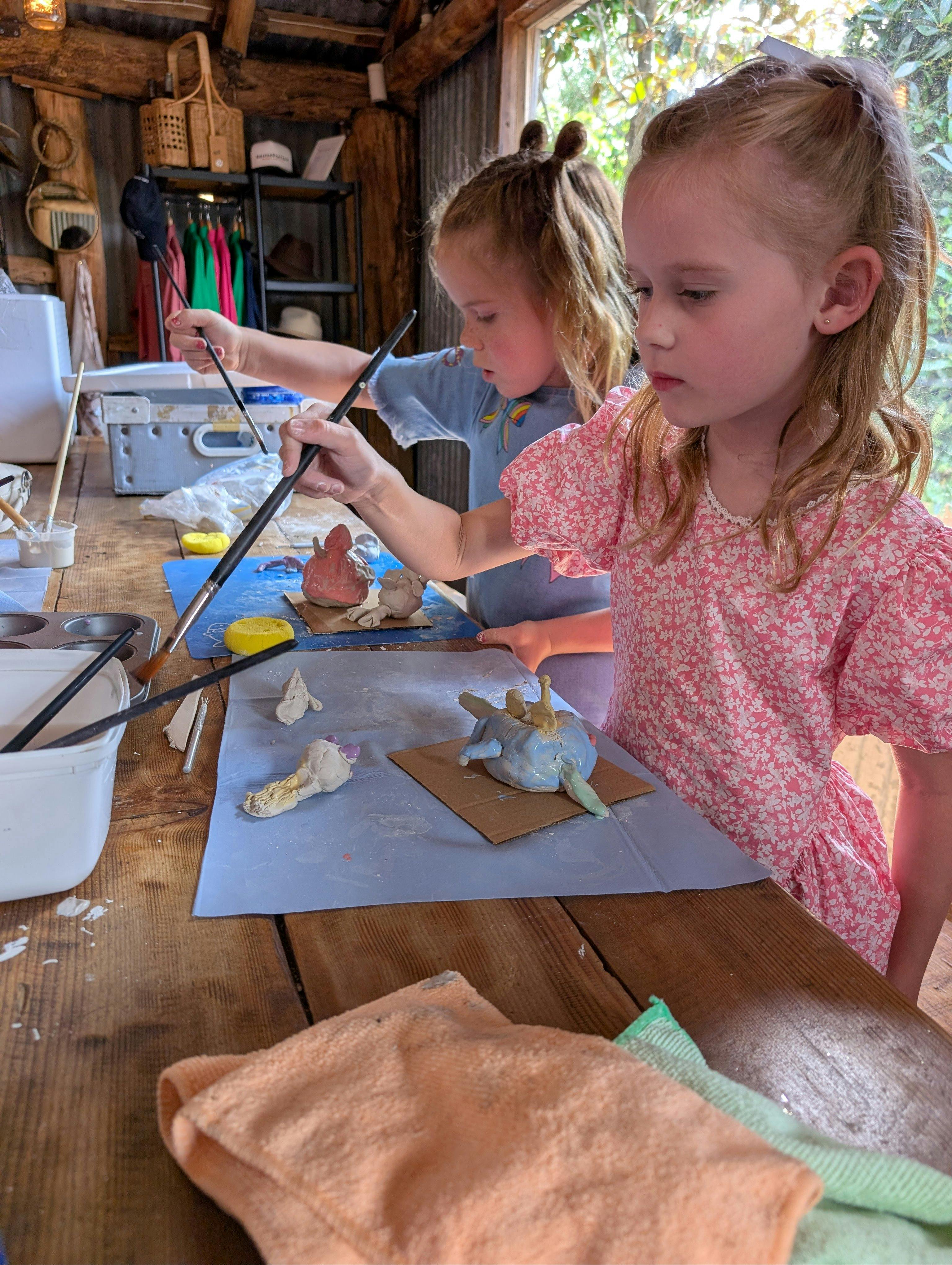 Kids painting pottery