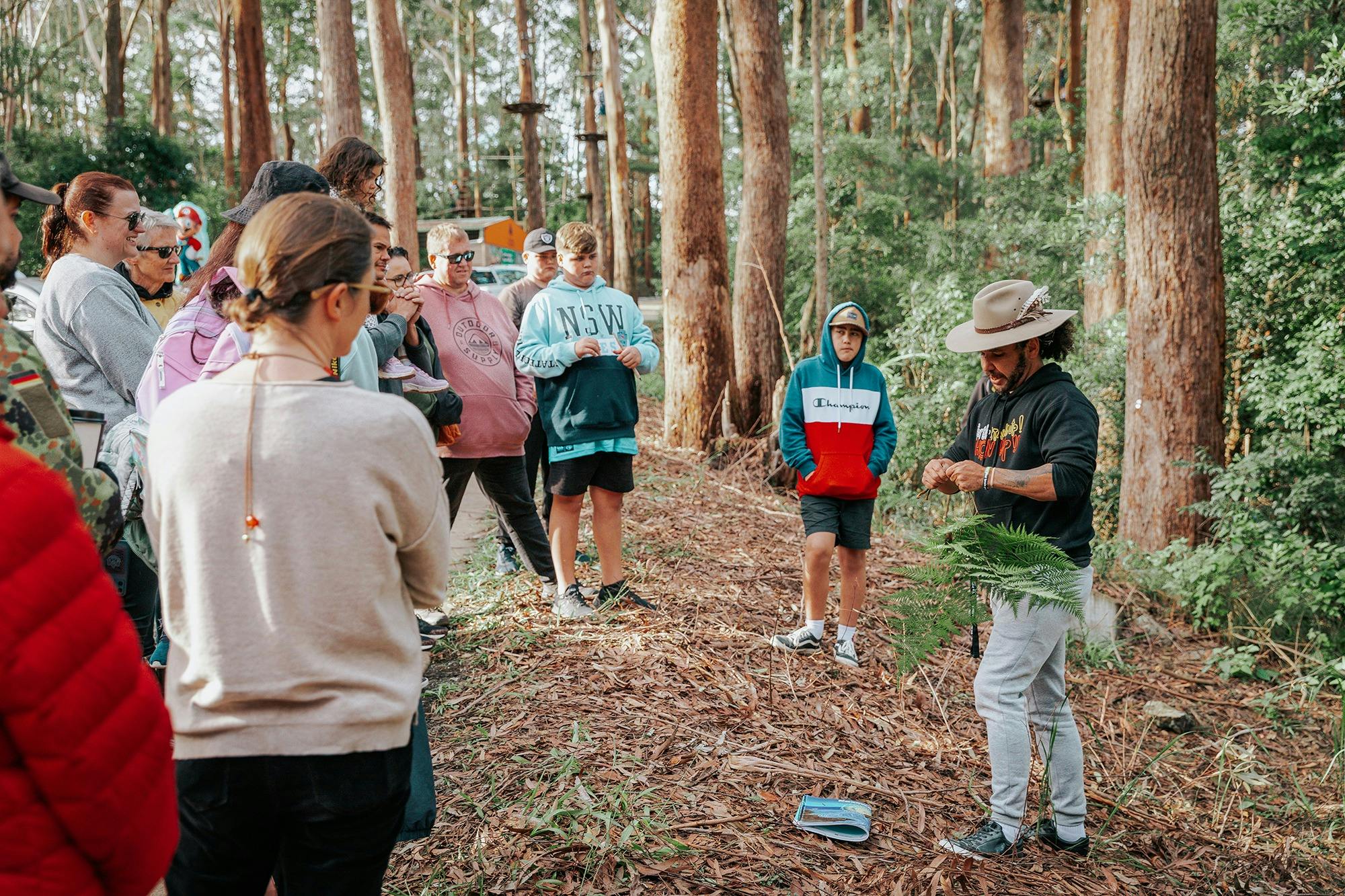 Aboriginal man teaching about plants on guided bushwalk for Giingan Tour Coffs Harbour