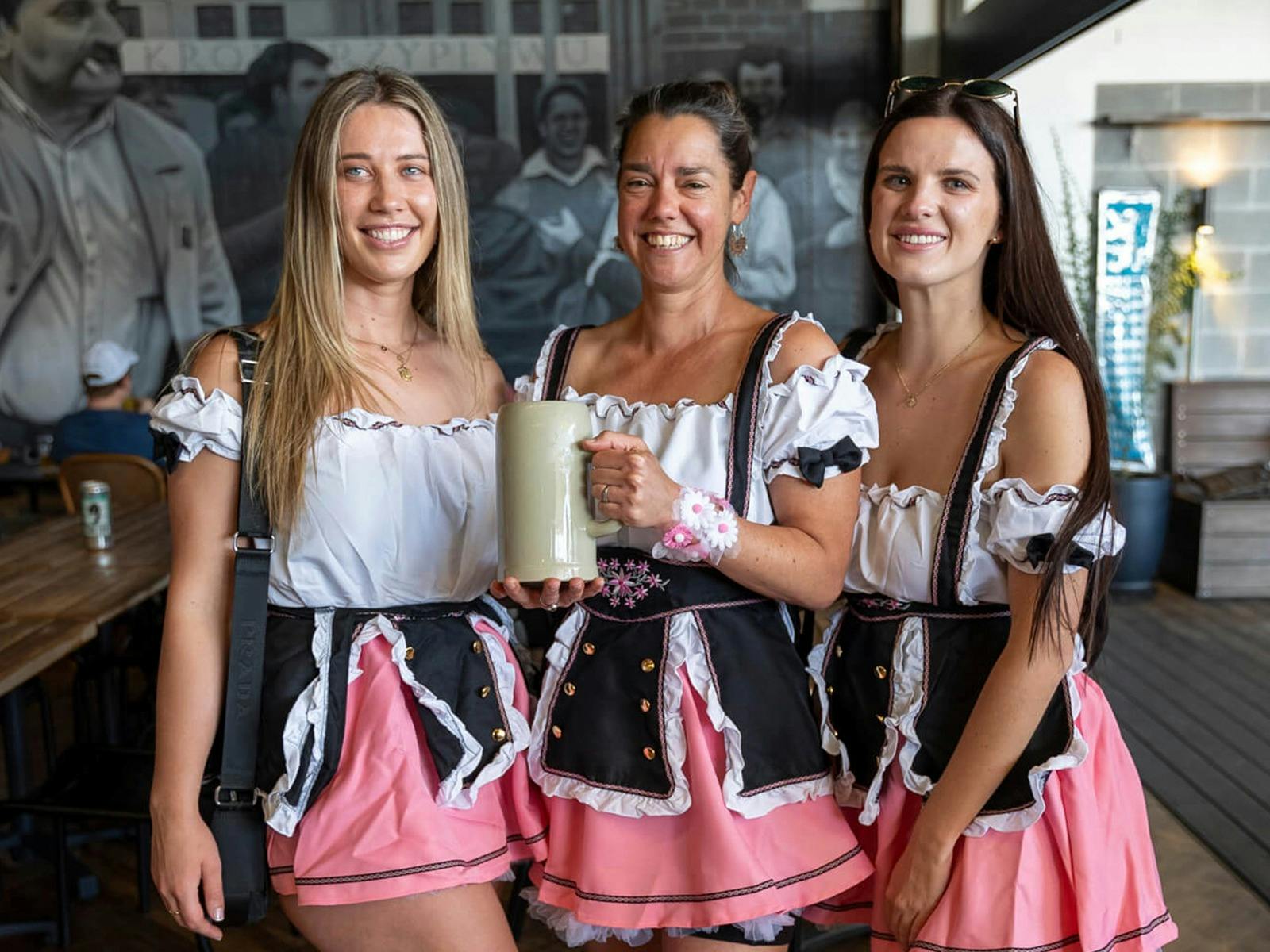 3 ladies wearing dirndles for the Oktberfest dress up competition