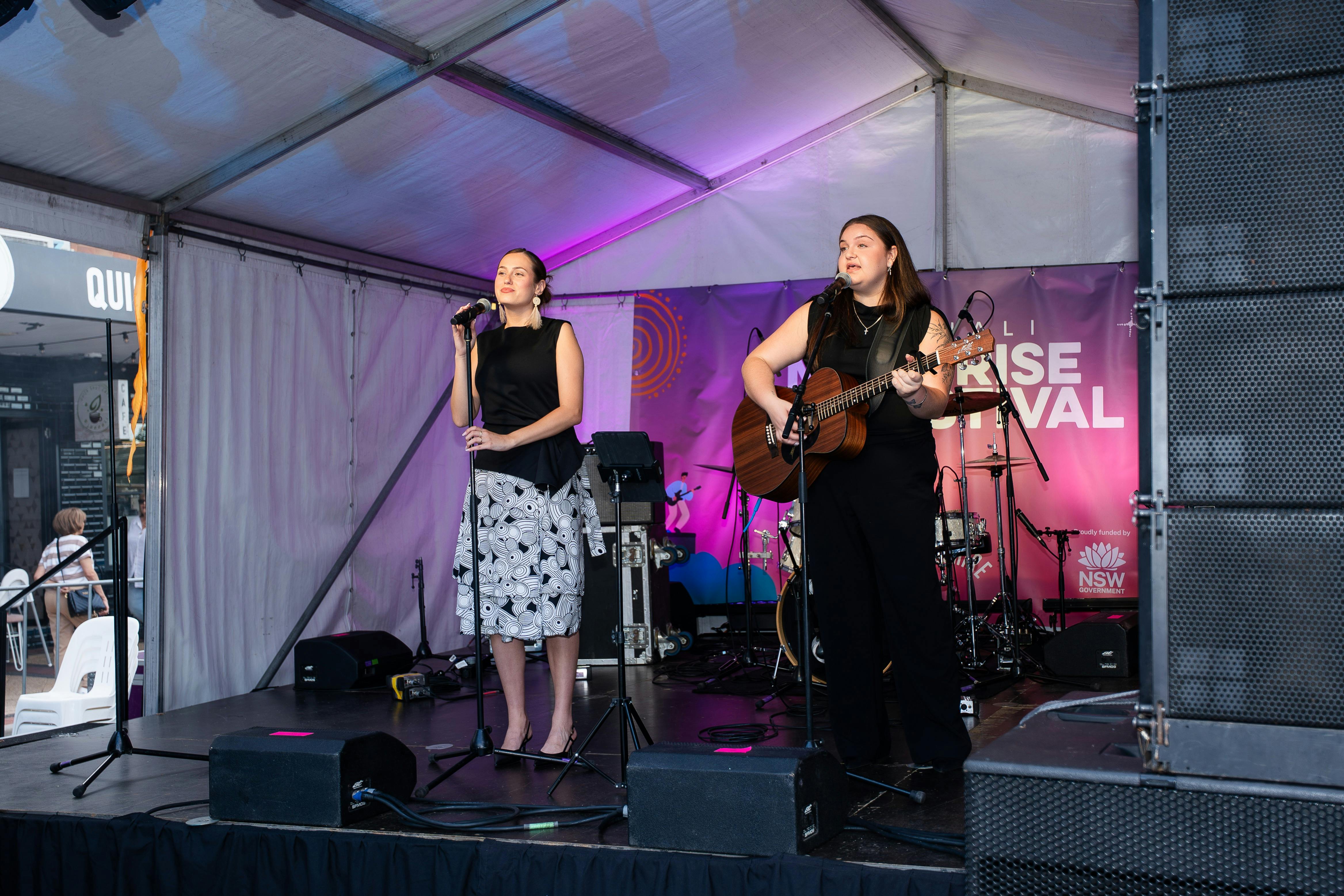 performers singing on stage