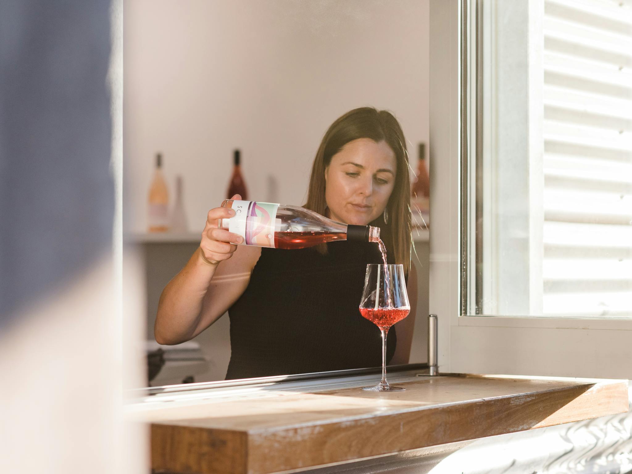 Woman pouring light red on windowsill