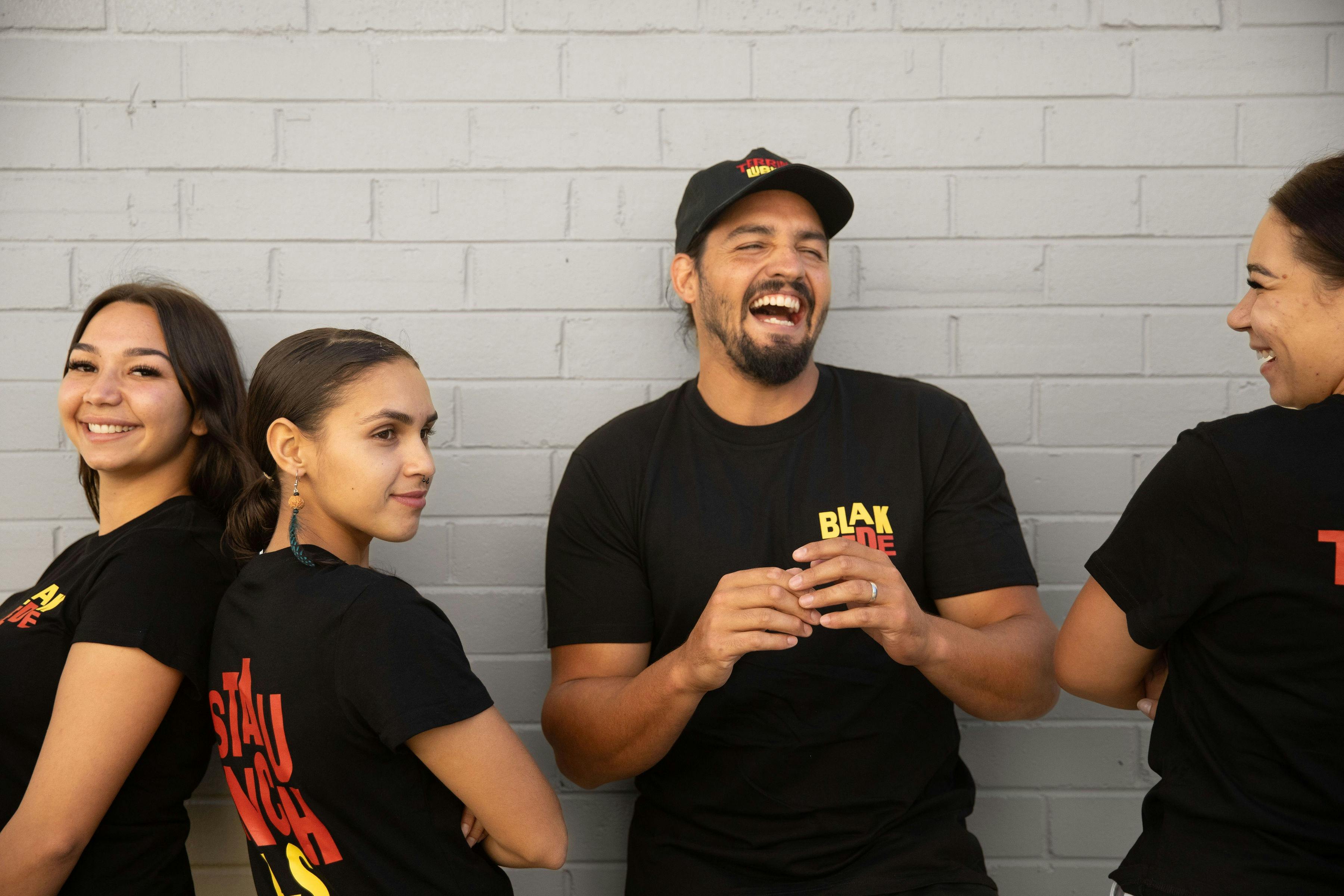 Four Blak Cede staff wearing Blak Cede mechandise