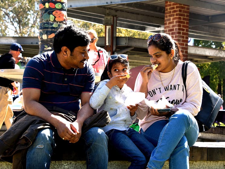 family of three enjoying wood fired pizza