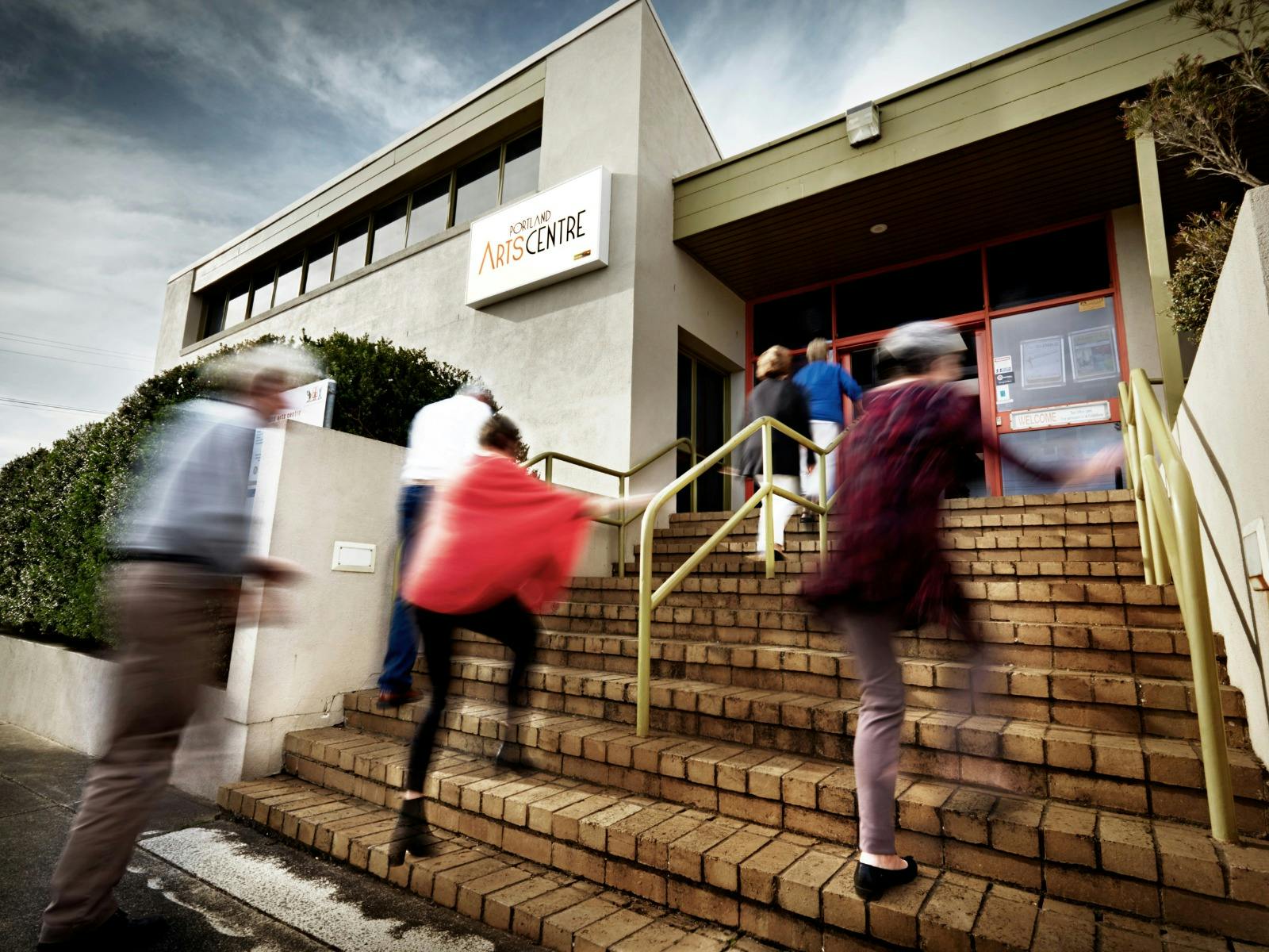 Patrons climbing the steps to the entrance