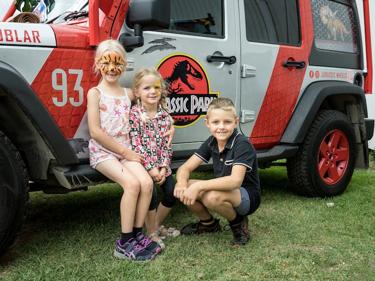 Kids at Minerama in front of Jurassic Park themed jeep