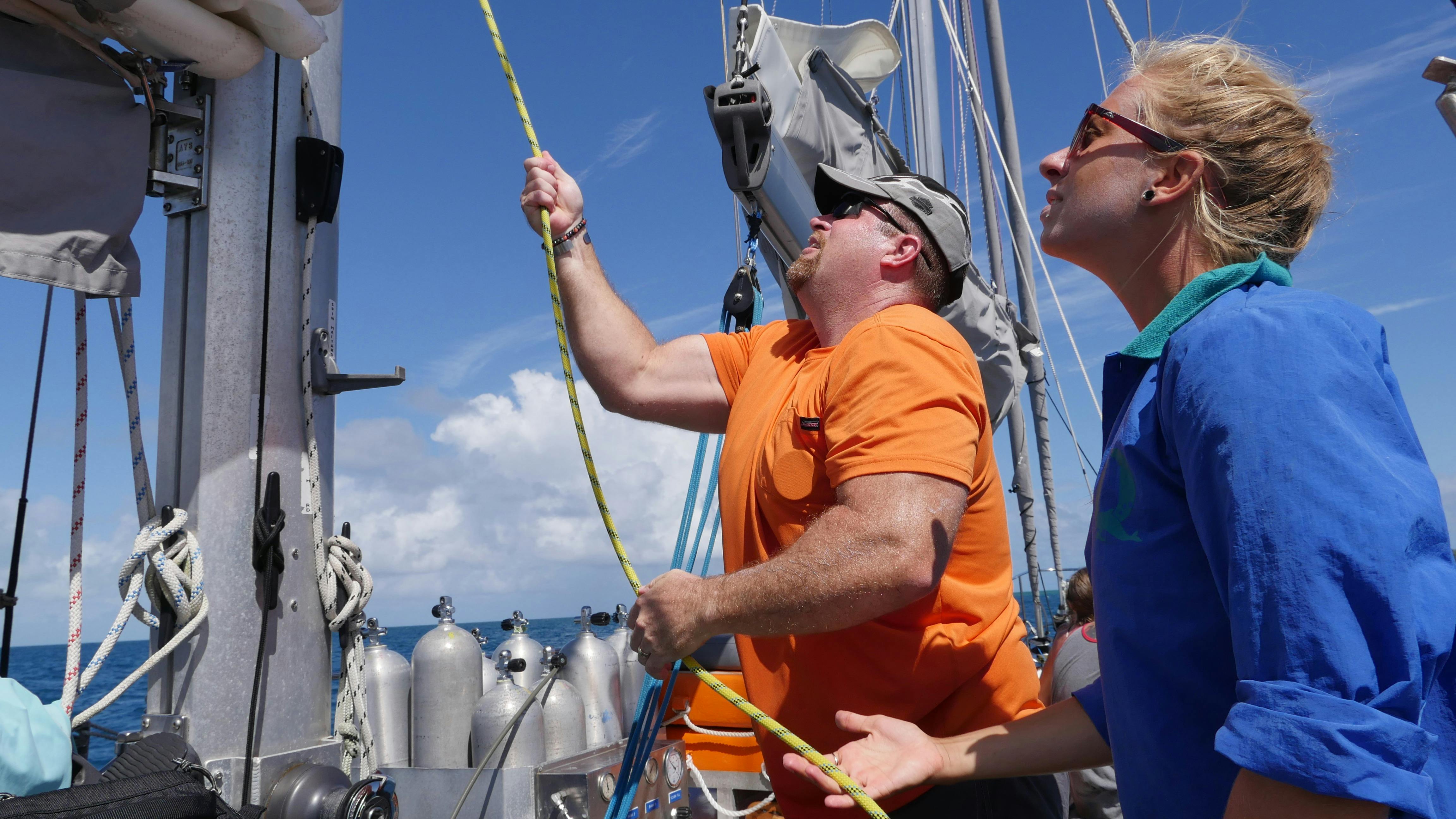 Hoisting the sail on Ocean Free under crew guidance