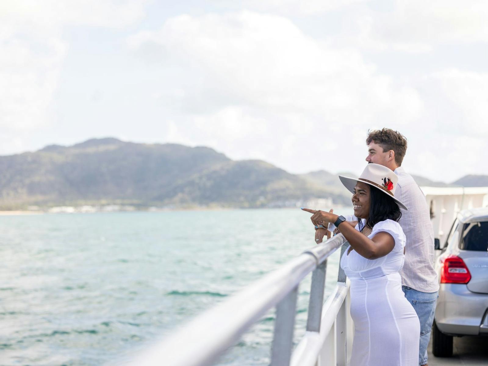 Two passengers standing on the vehicle deck of Magnetic Island Ferries looking toward Magnetic Two passengers standing on the vehicle deck of Magnetic Island Ferries looking toward Magnetic
