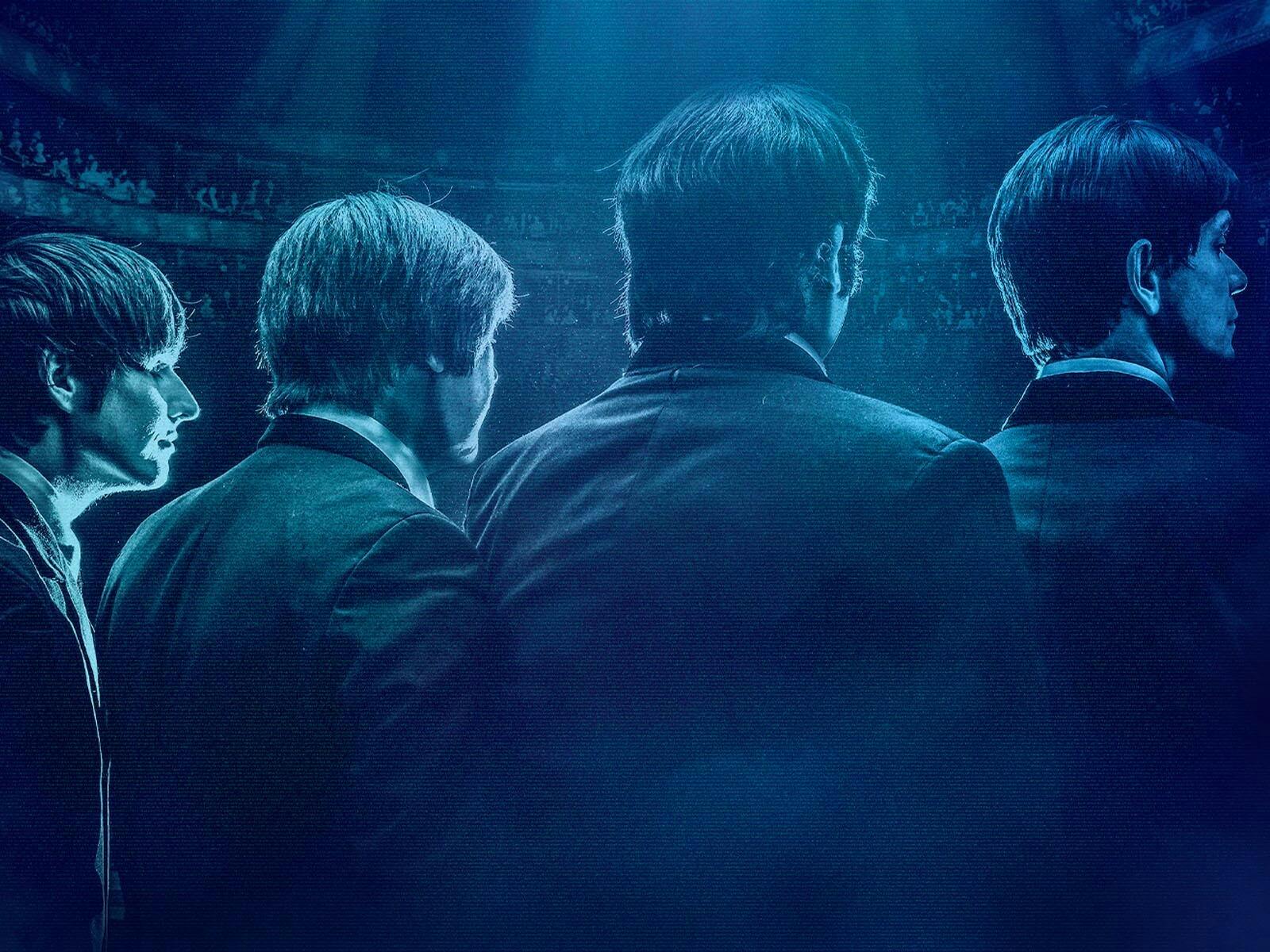 Four men in black suits staring out to an audience, tinted with a blue overtone