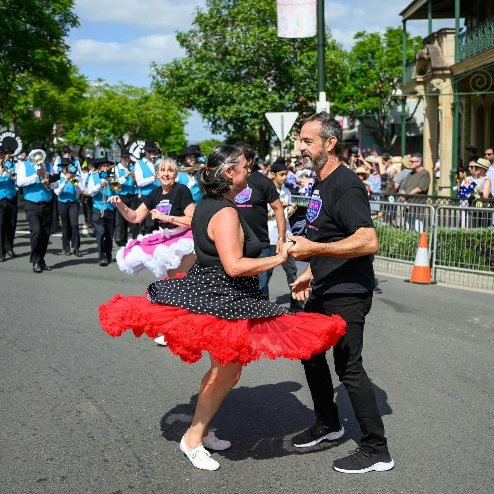 Two people jiveing in a street parade