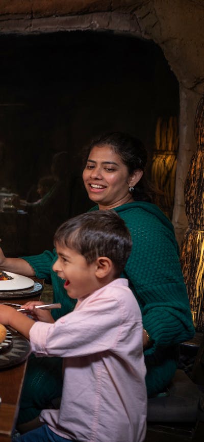 Family dining in Cave Restaurant with Jake the white lion.