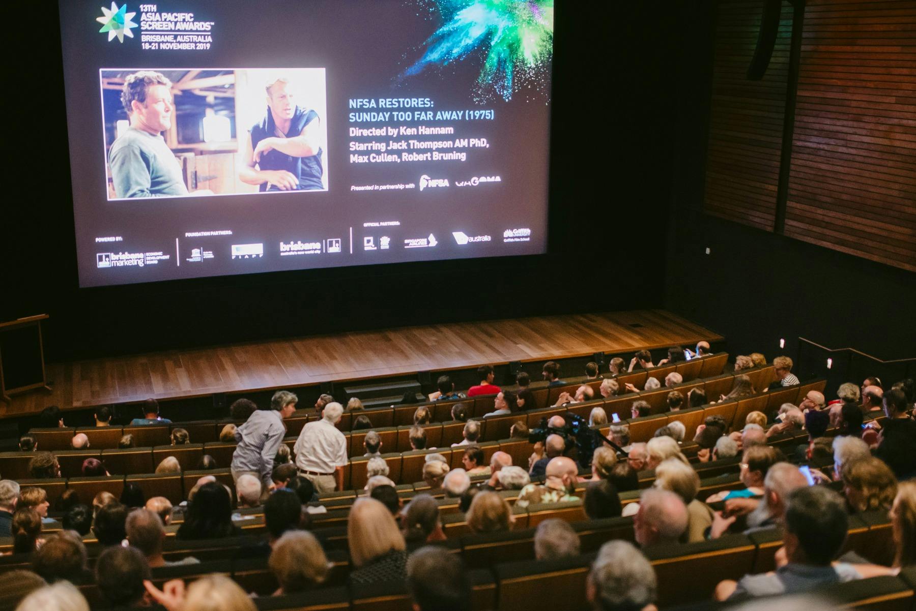 Cinema filled with audience looking at a screen