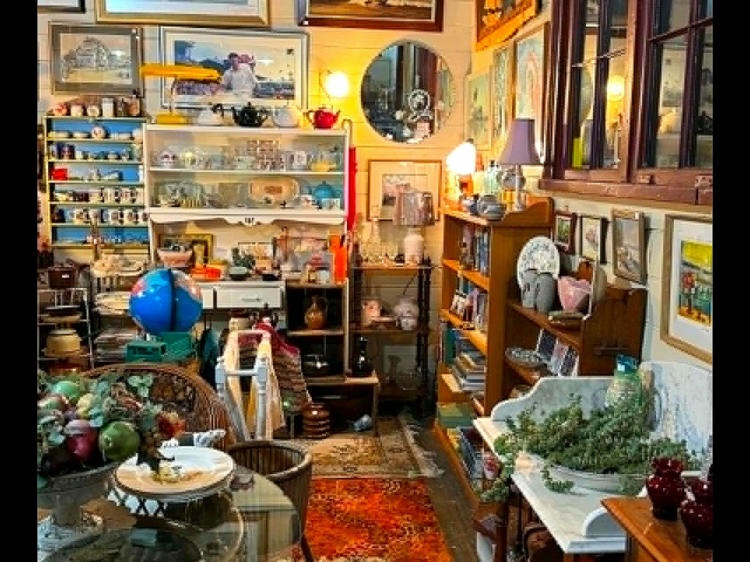 Retro kitchenalia nook with globe, teapots, glassware and books