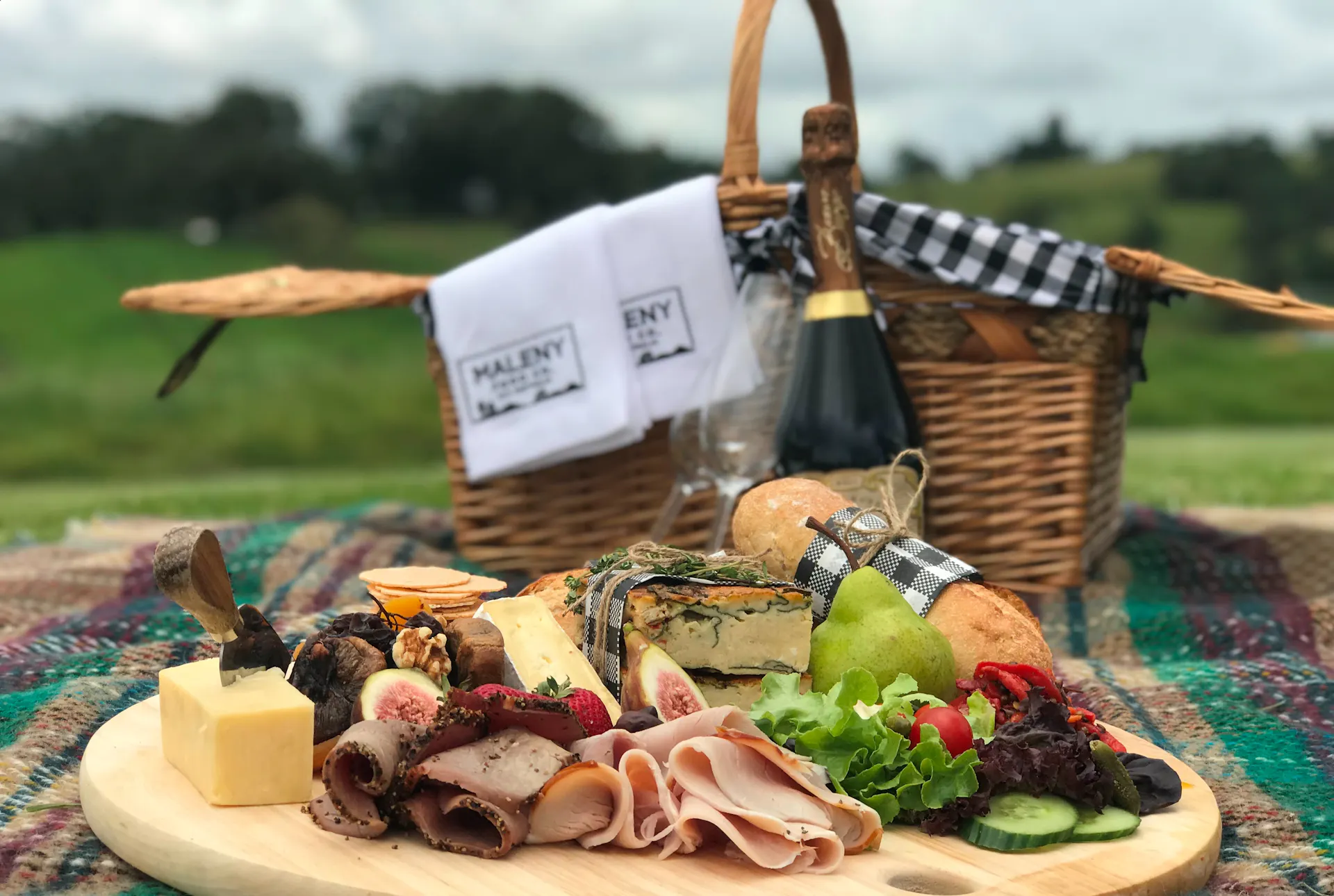 Picnic hamper including cheese and meats from our fromagerie  and a bottle of champagne.