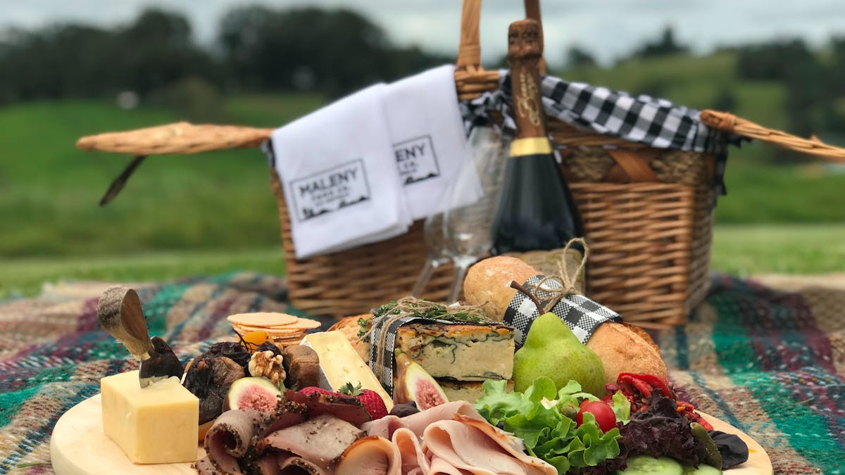 Picnic hamper including cheese and meats from our fromagerie  and a bottle of champagne.