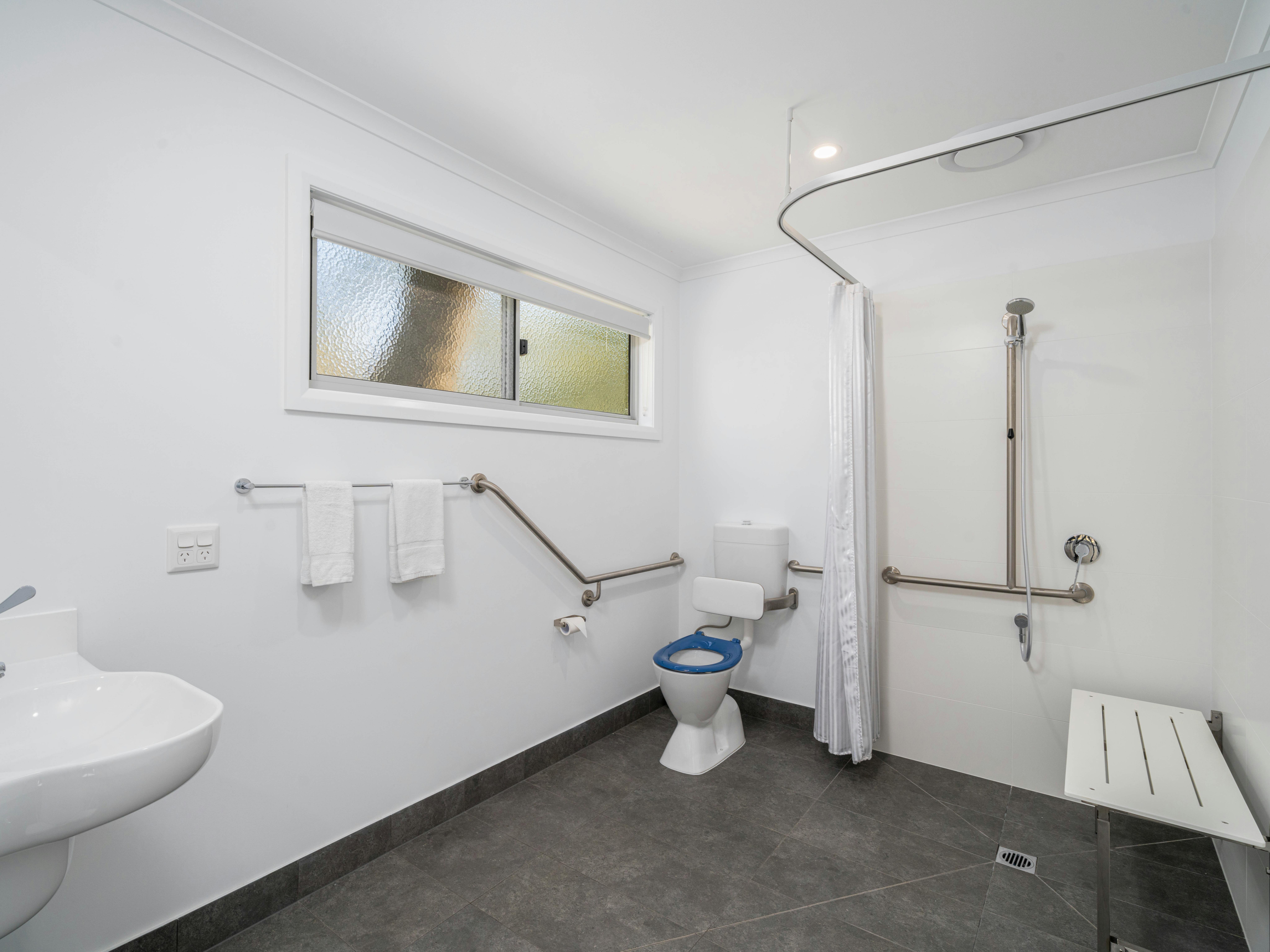 Premium family cabin showing large wheel chair friendly and accessible bathroom