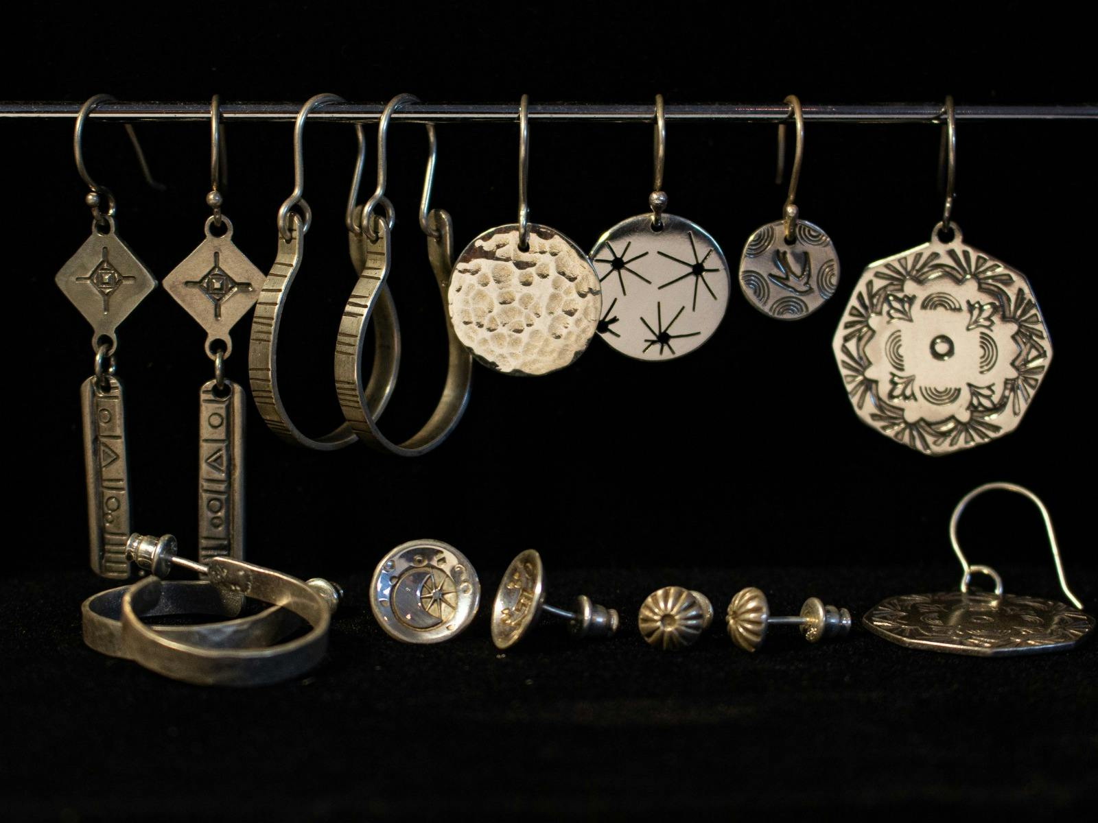 Set of silver stud and drop earrings