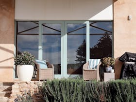 Outdoor terrace with barbecue, seating and landscaped garden.