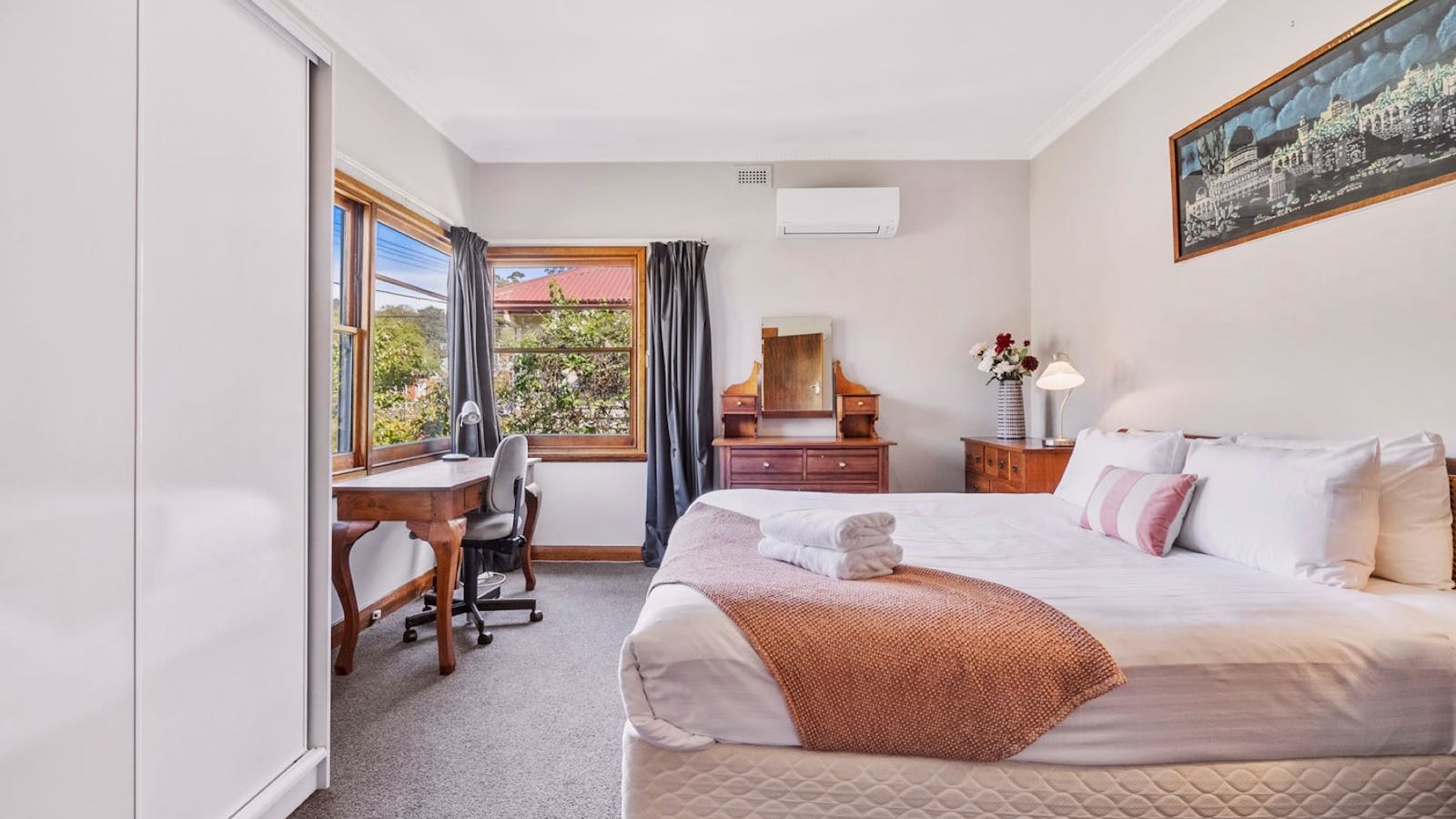 Main Bedroom with King size bed, air conditioner and built ins