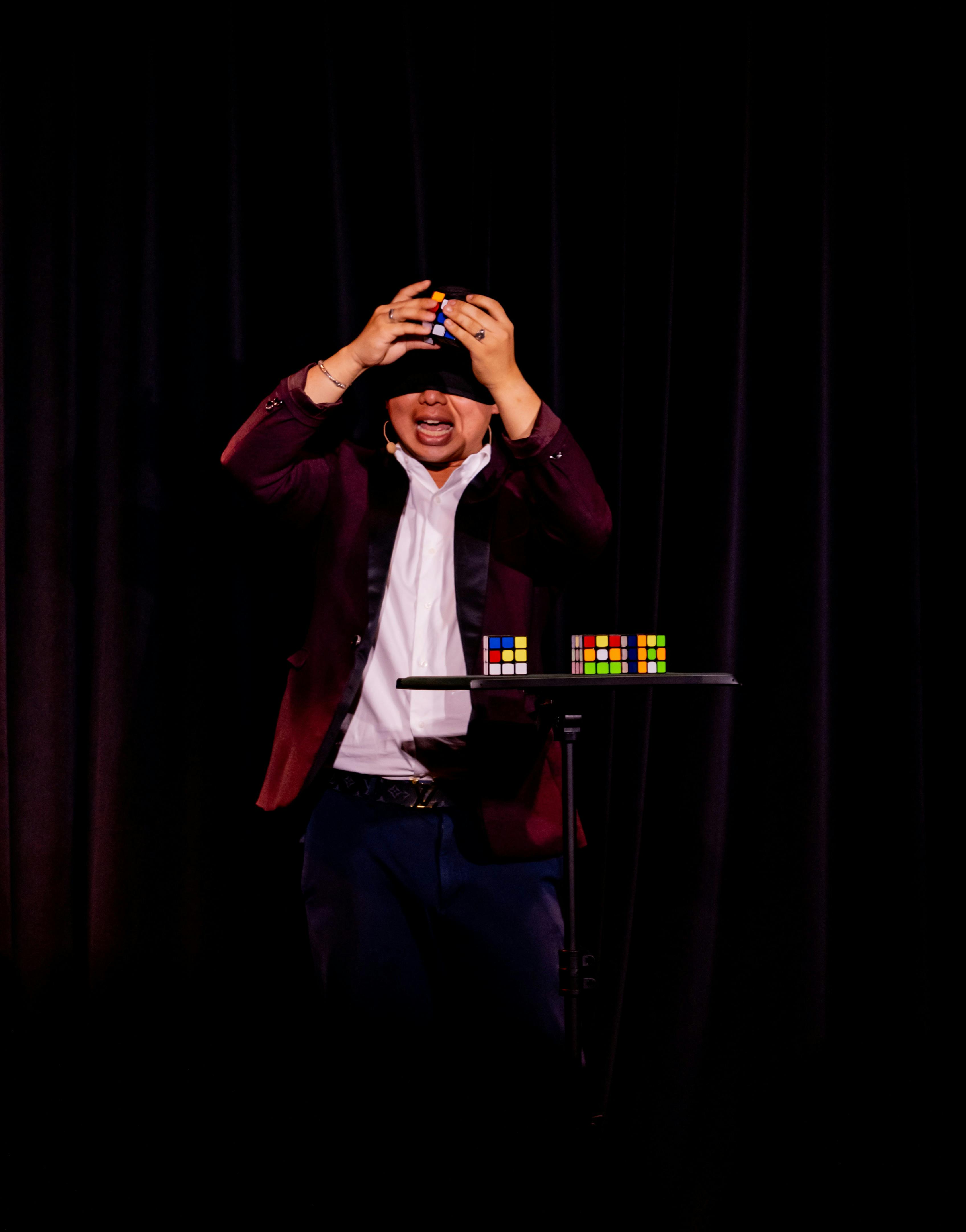 Clement Holding Rubicks Cubes Blindfolded