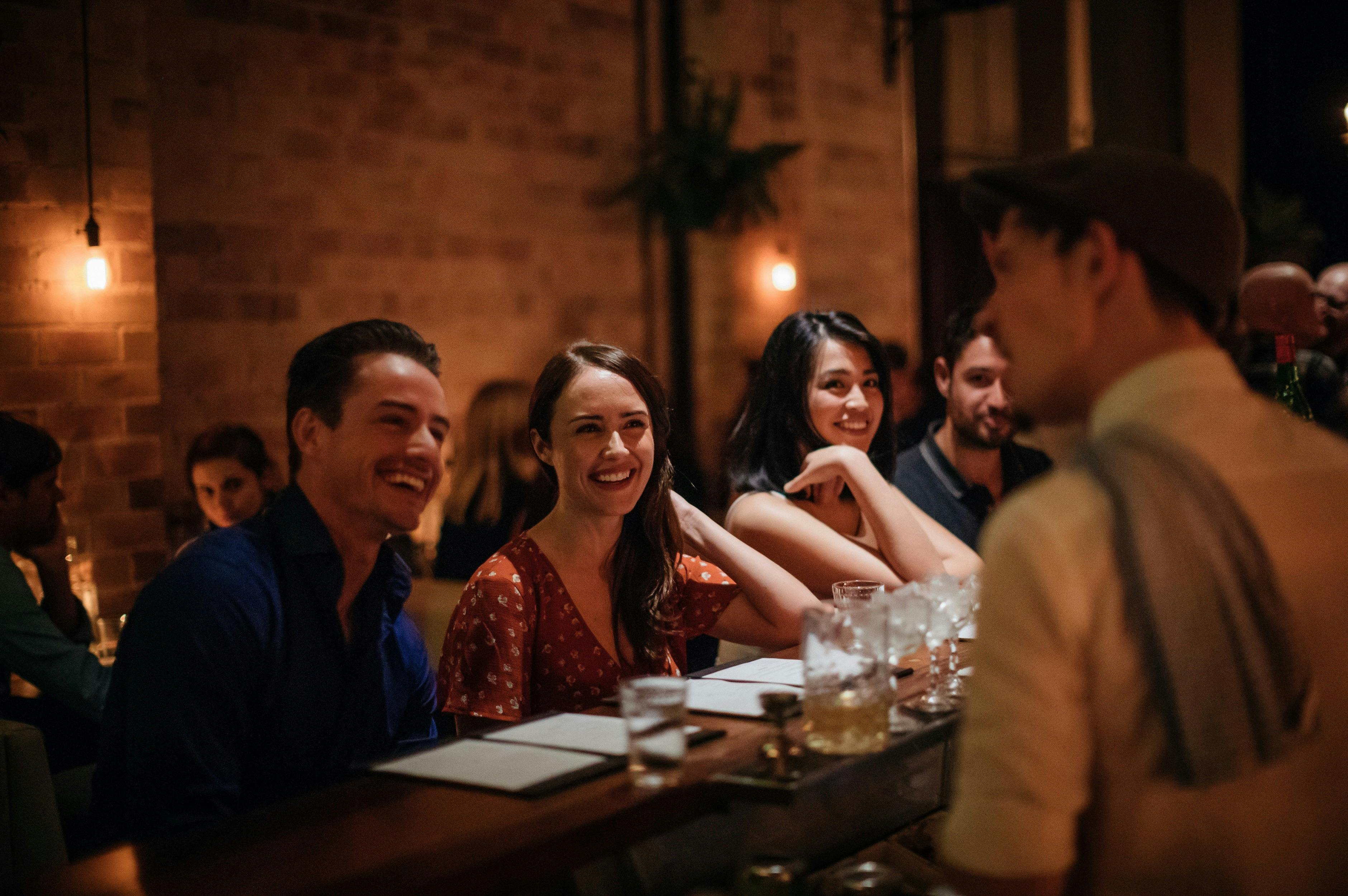 Bartender pouring cocktails for patrons at retro-chic bar Coal & Cedar in Newcastle