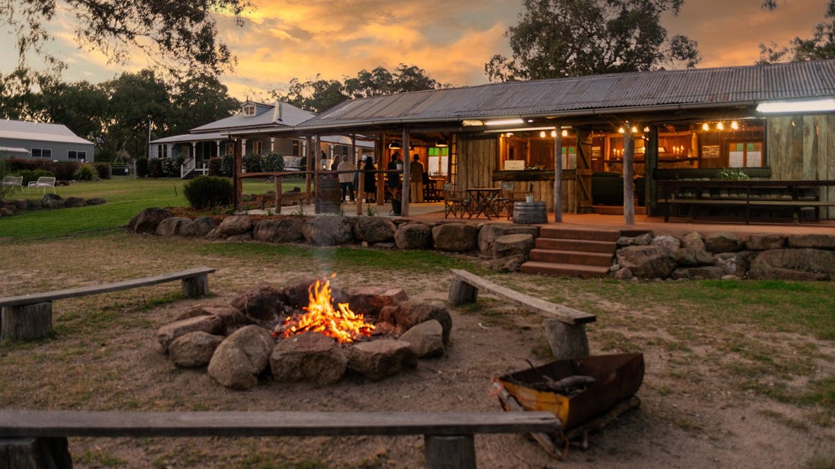 timber hut with surrounding bushland and outdoor fire pit