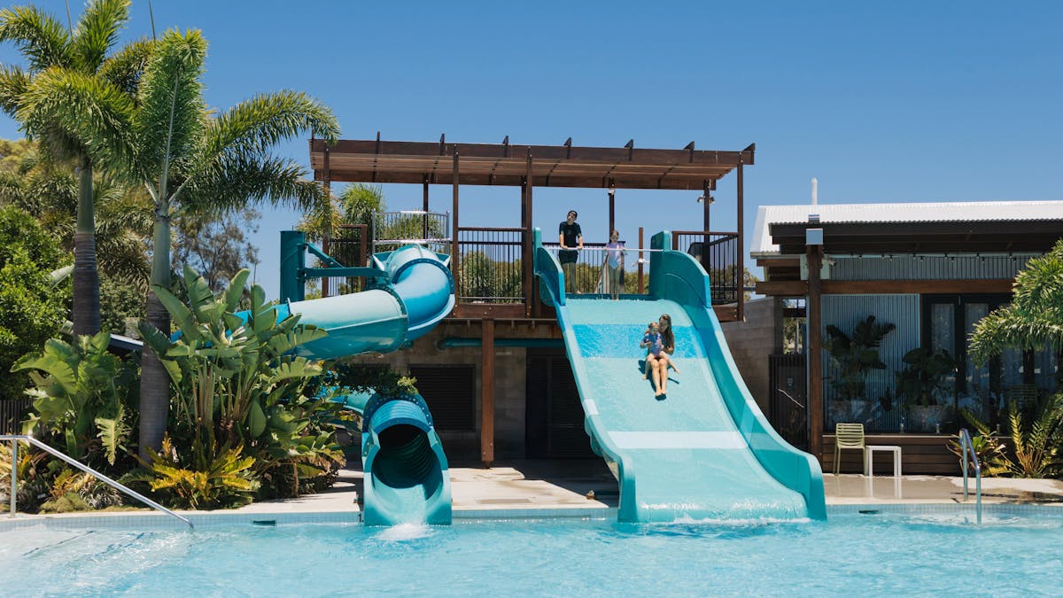 Two waterslides into a crystal clear pool