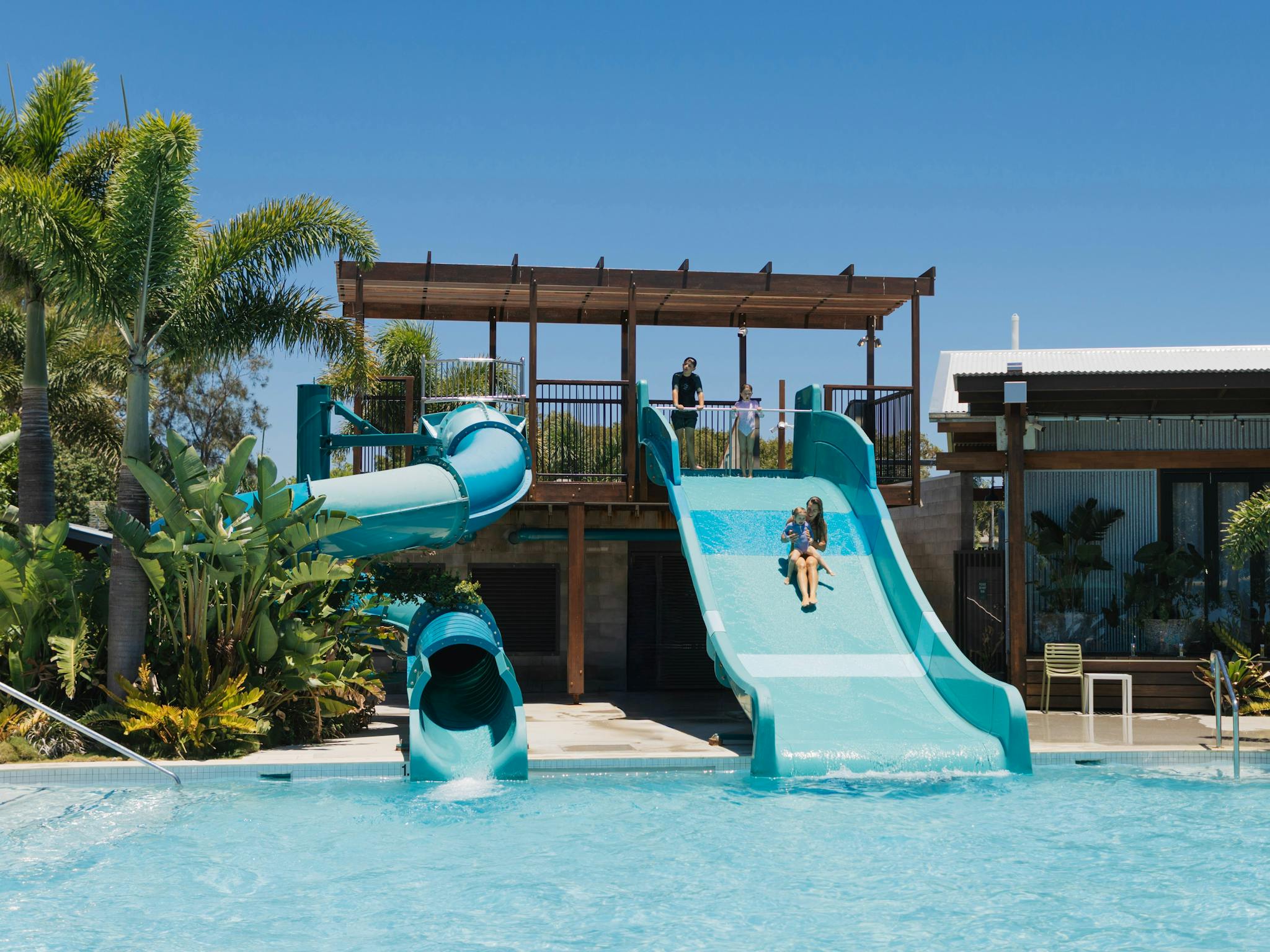 Two waterslides into a crystal clear pool Two waterslides into a crystal clear pool