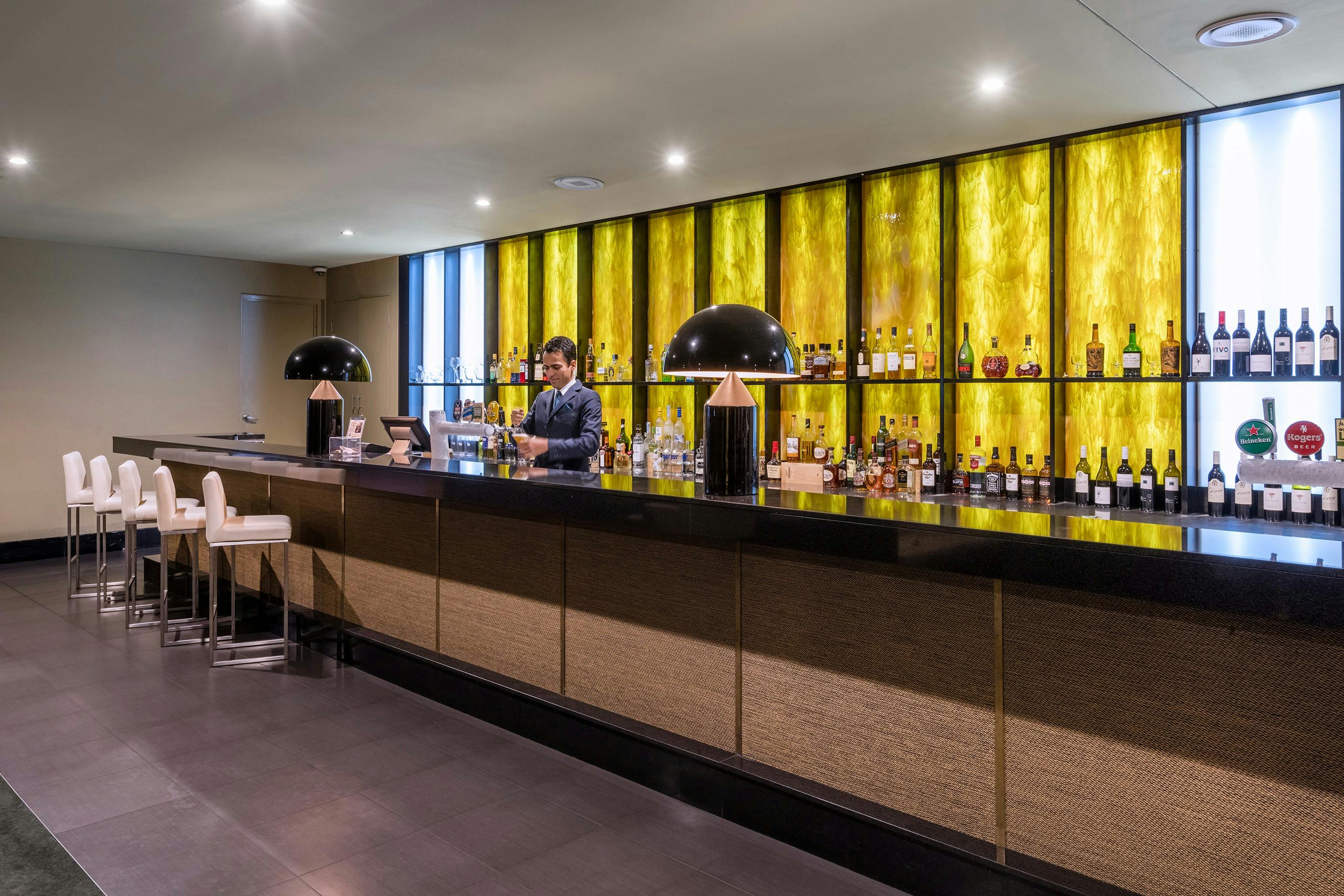 KG Bar with team member pouring a beer