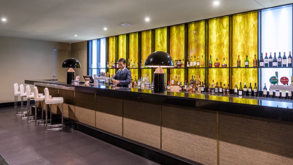 KG Bar with team member pouring a beer
