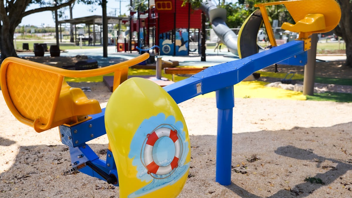 Blue and yellow children’s cycle play equipment at Beth Boyd Park, Thorneside, Redlands Coast.