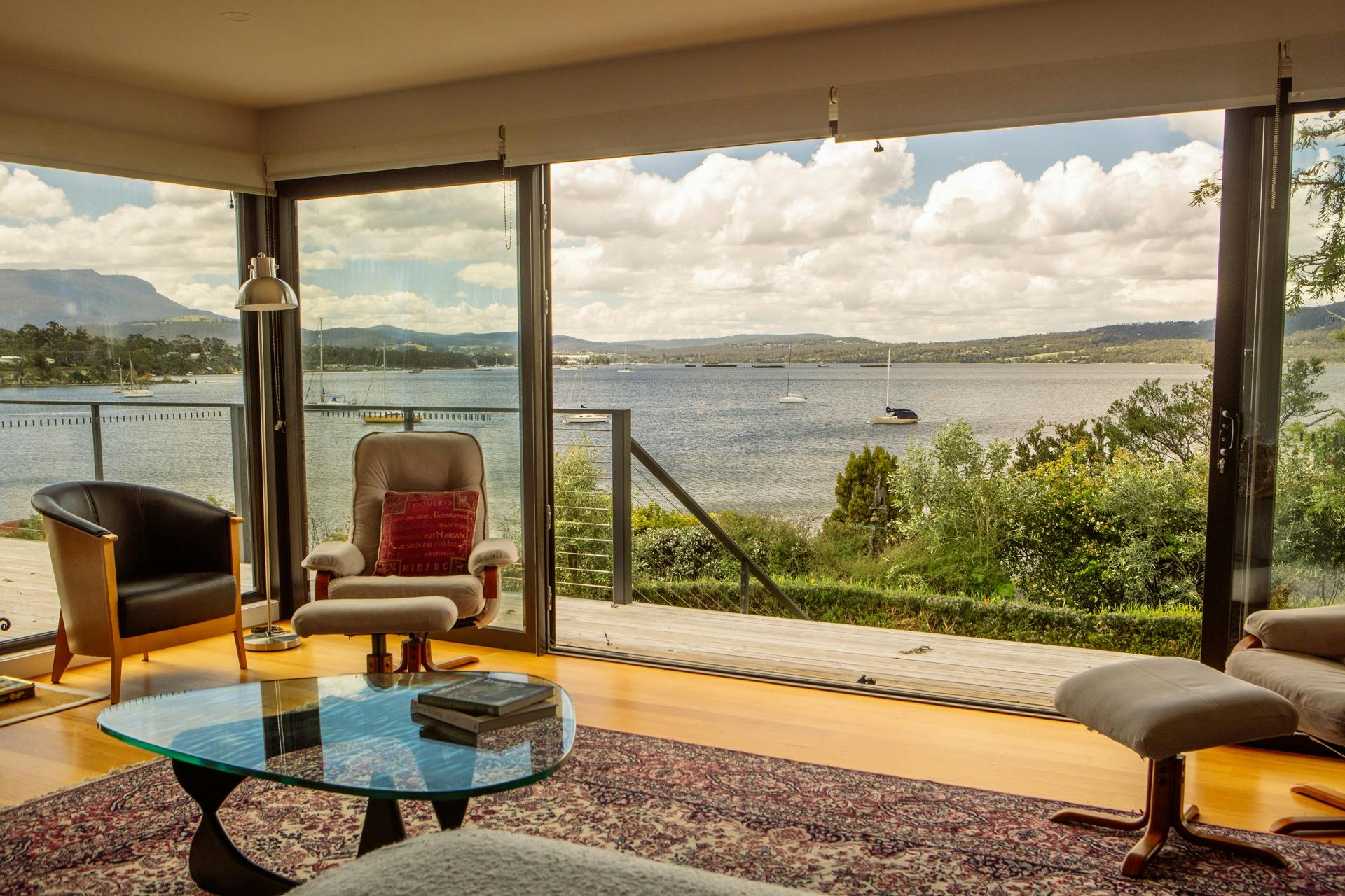 Panoramic sea and mountain view from the living room at Snug on the Bay