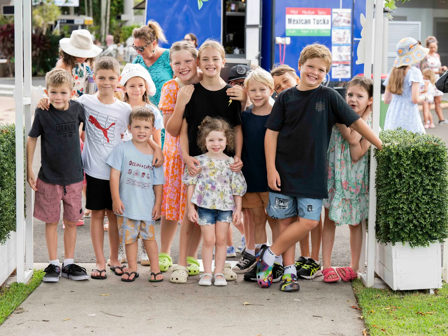 Group of kids smiling at the camera waiting for the easter egg hunt