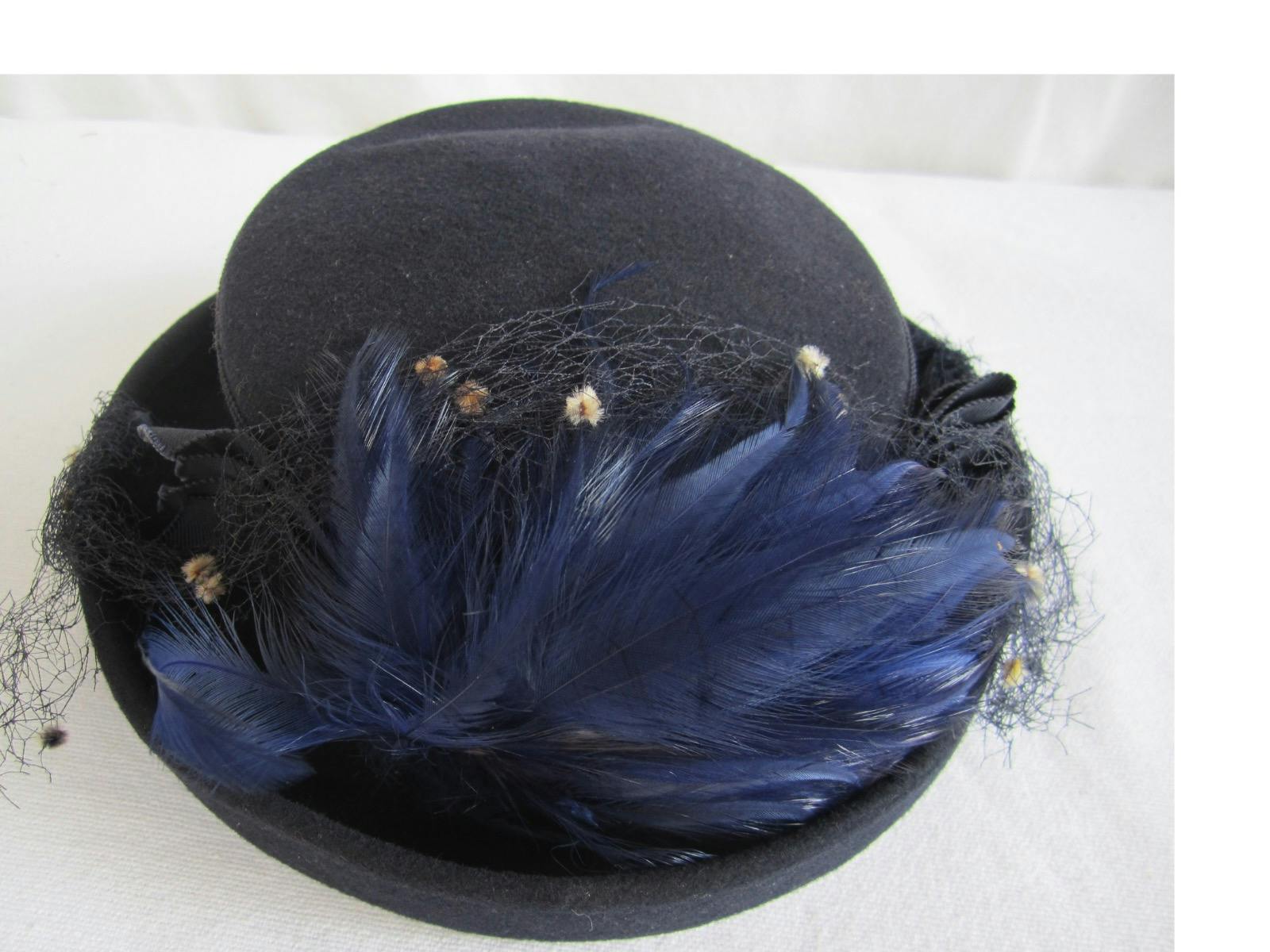 Hat trimmed with feathers and netting