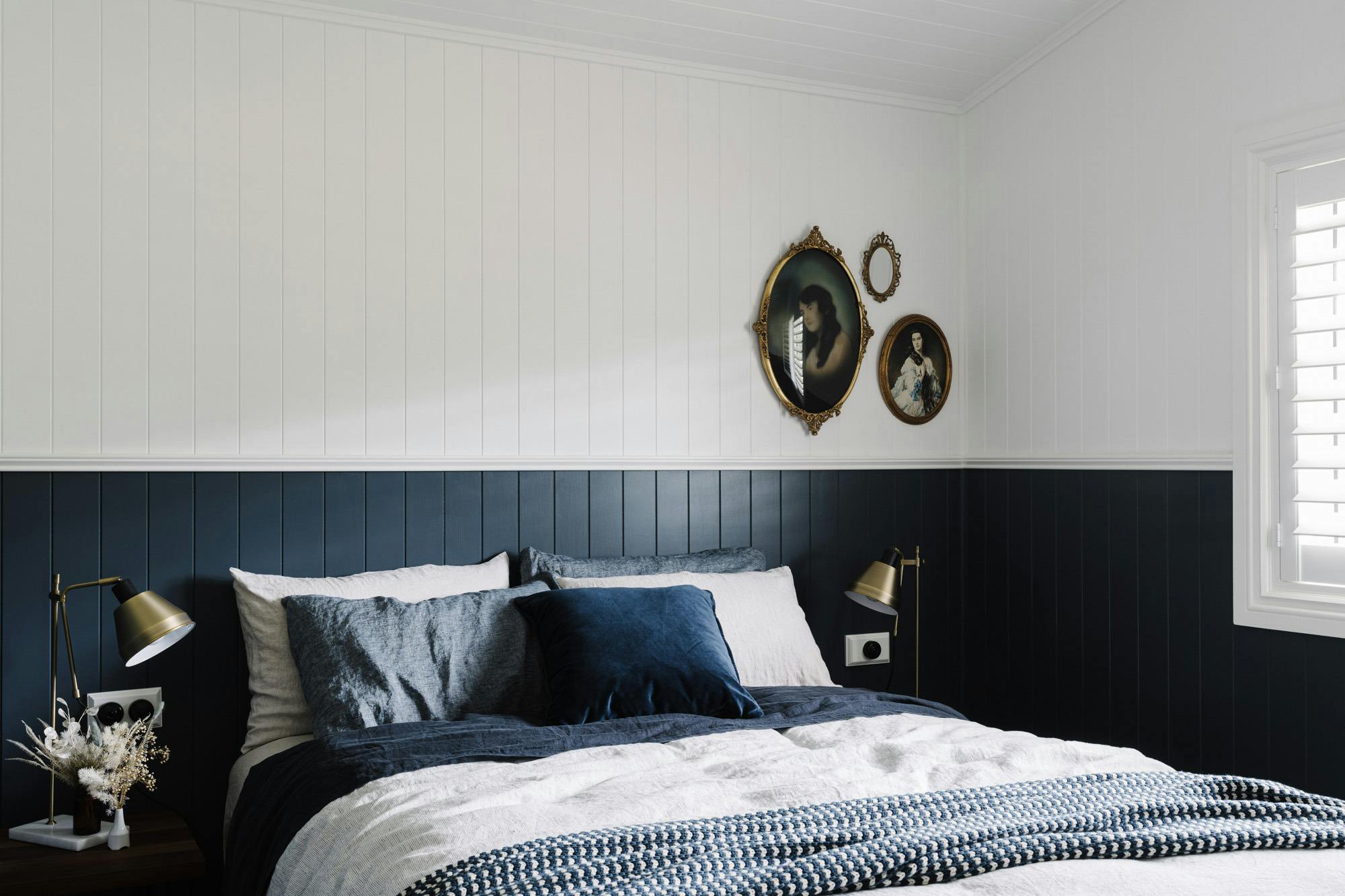 Bedroom 2 luxury linen sheets with vintage art on the white and navy  vj panelled walls