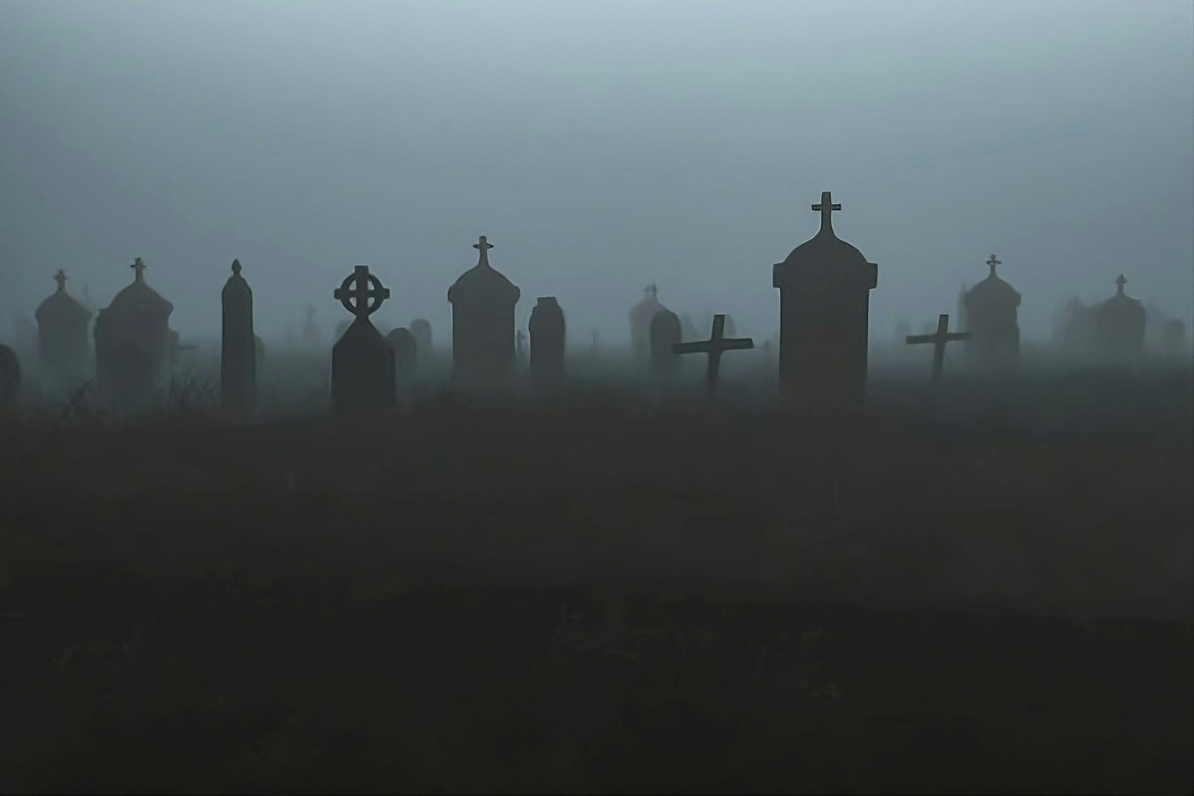Gravestones in misty cemetery