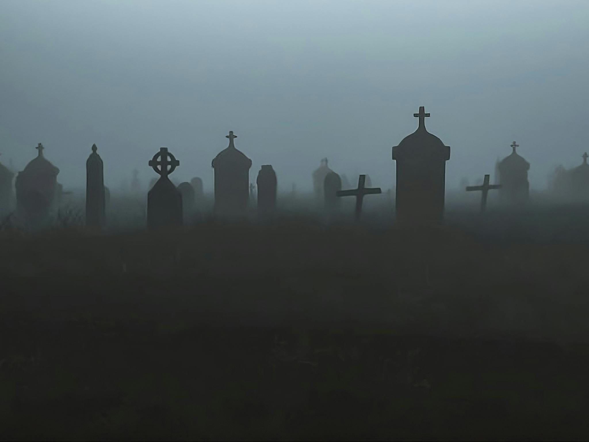 Gravestones in misty cemetery Gravestones in misty cemetery