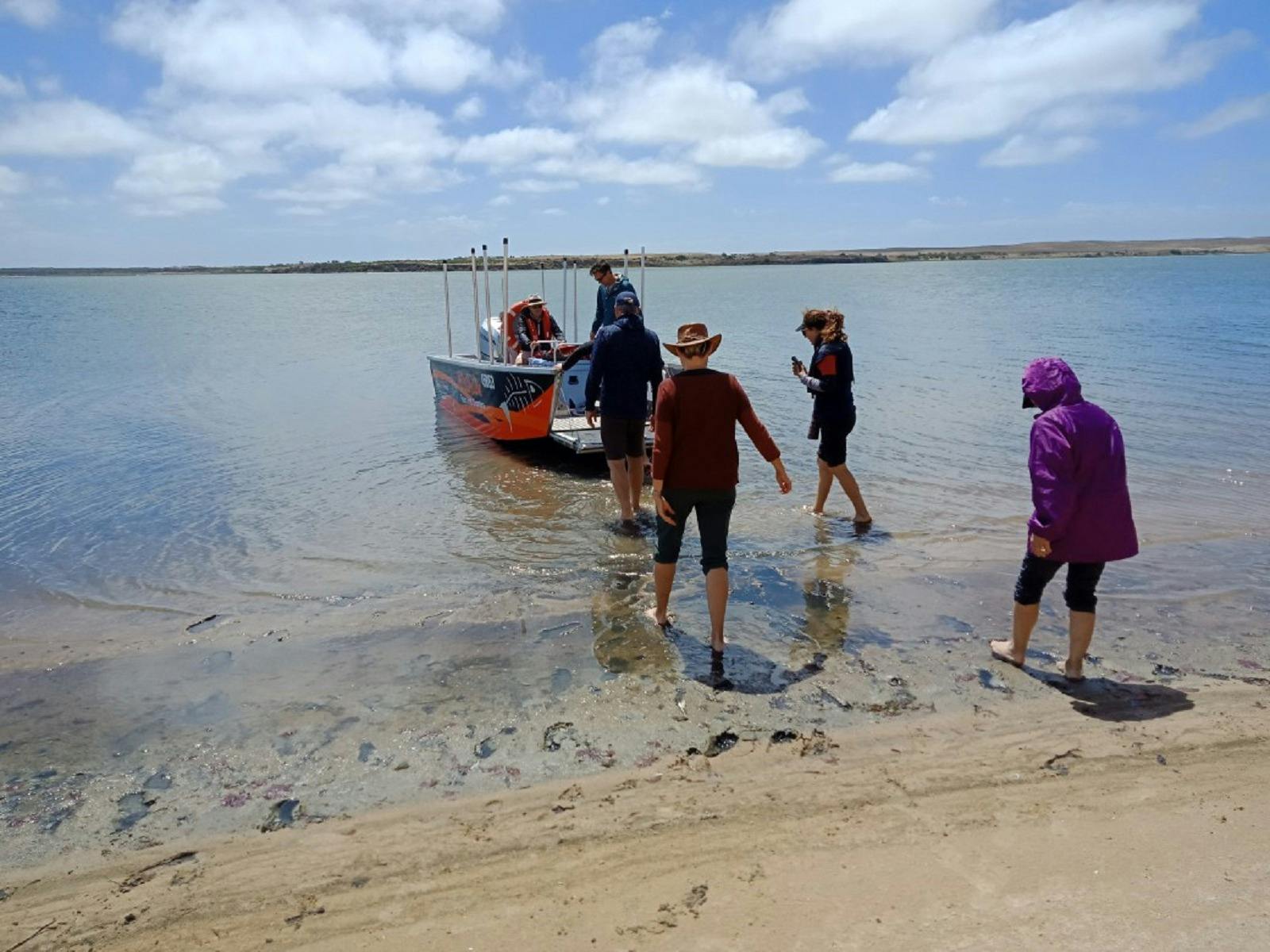 TOUR GROUP WALKING BACK TO BOAT AFTER A SHORE TOUR